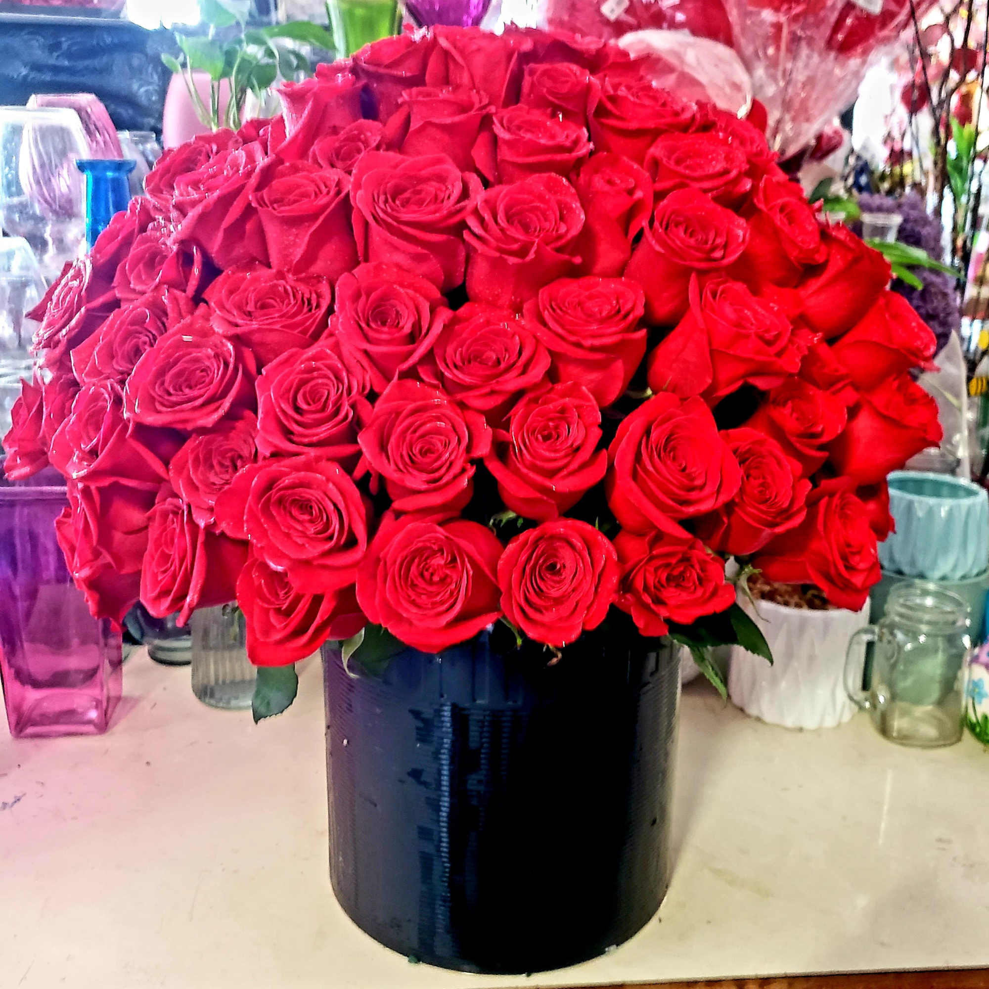 Large bouquet of red roses in a black vase