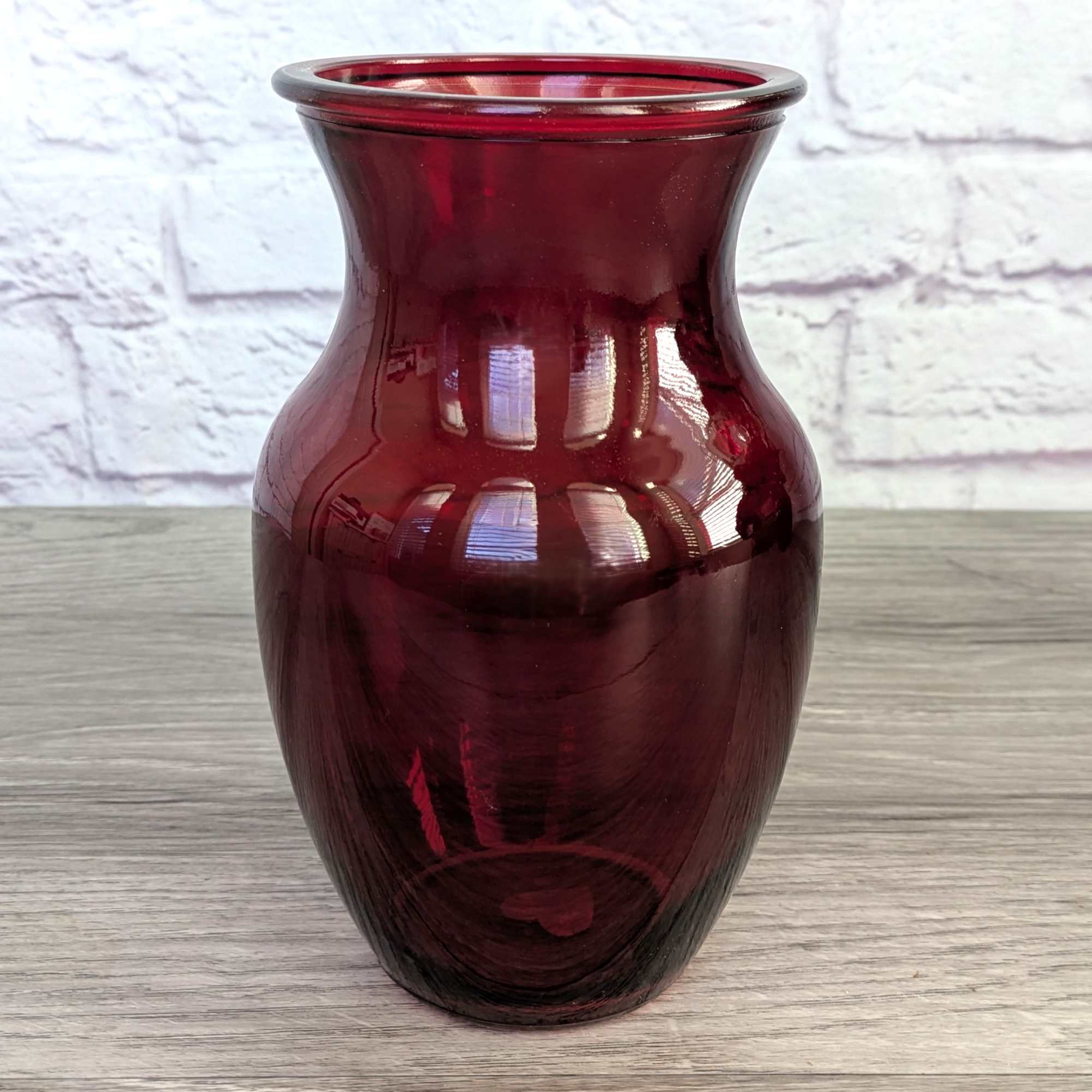 Burgundy glass vase with a flared rim