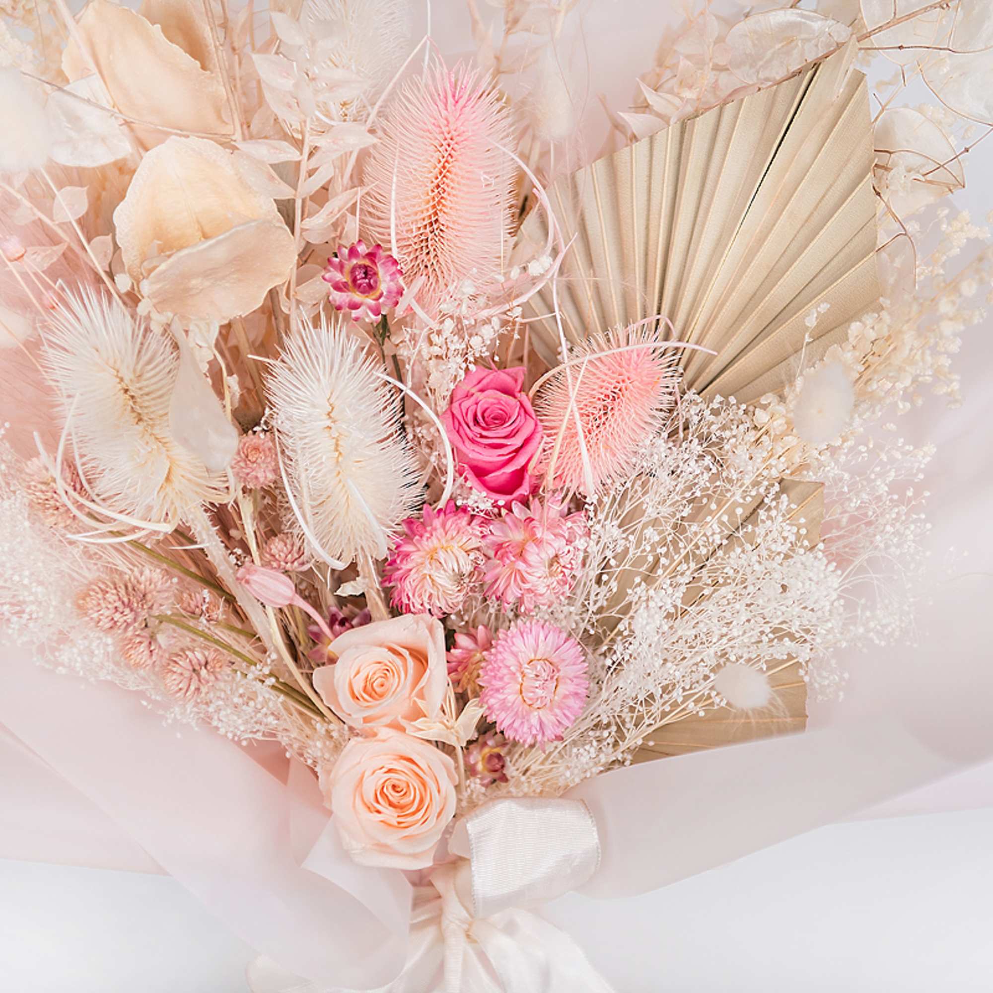 Pink and peach bouquet with roses and dried accents