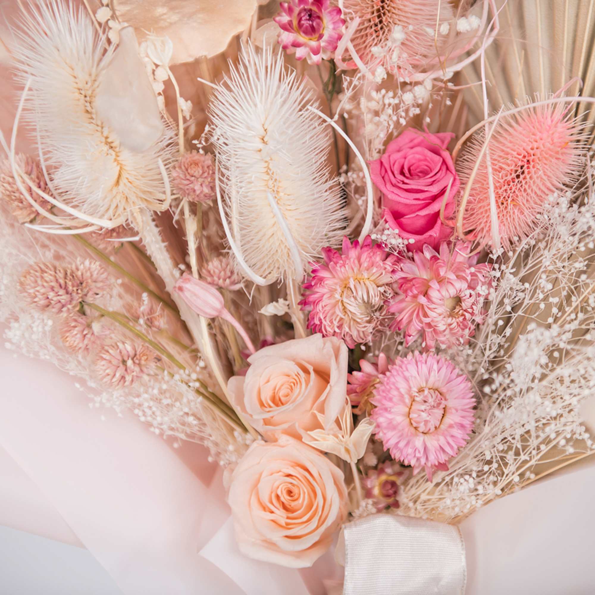 Pastel bouquet with pink and peach roses and dried flowers