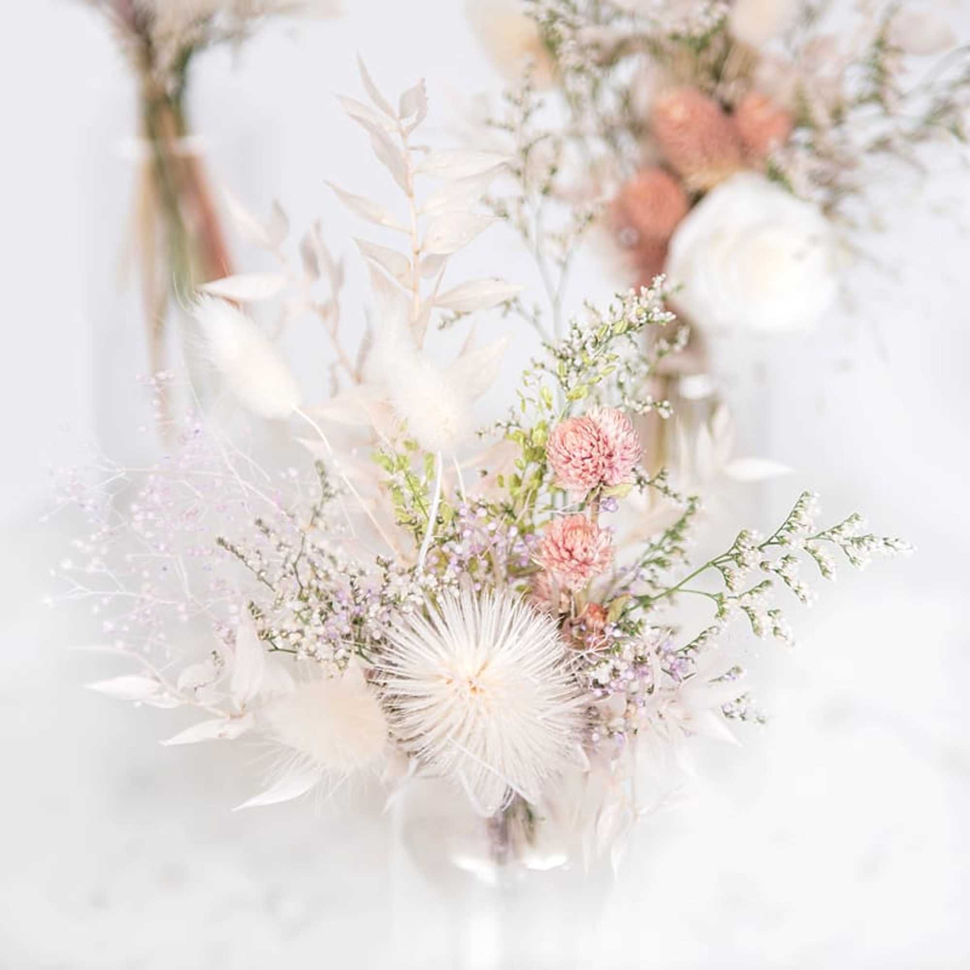 Soft pastel bouquet with white and pink blooms in a clear vase