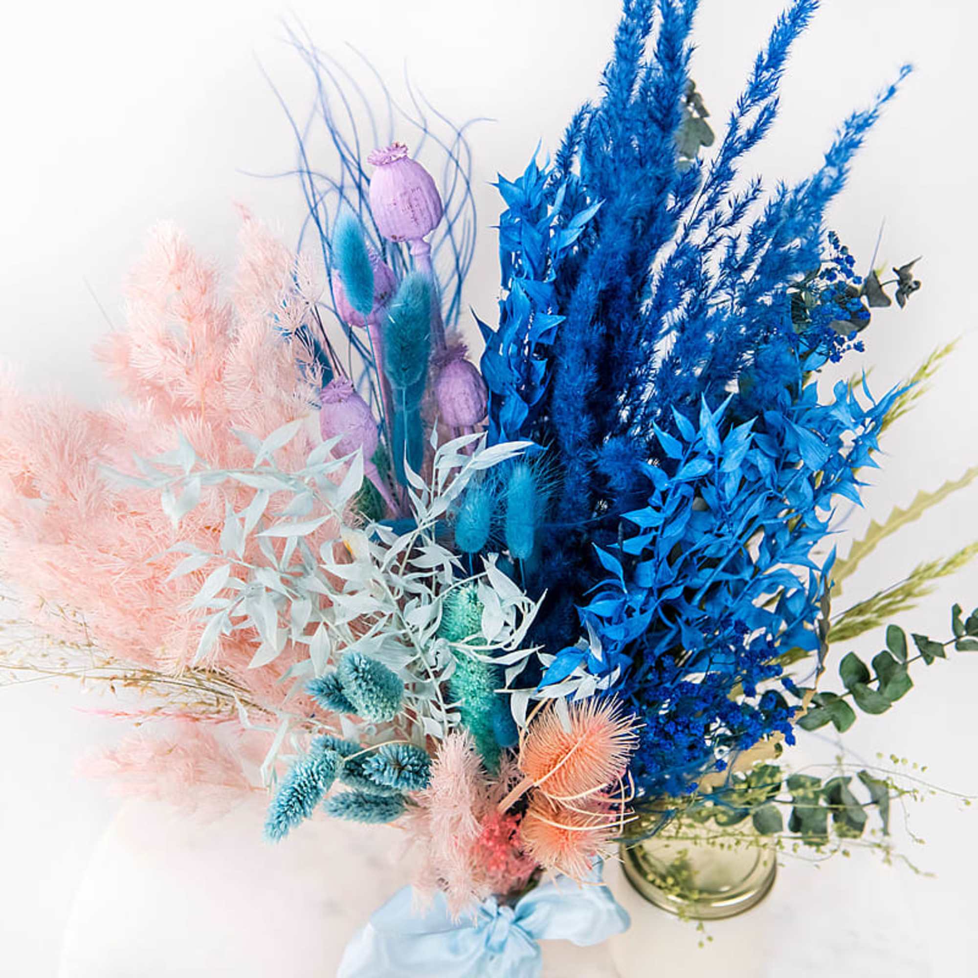 Colorful dried floral arrangement in a glass vase
