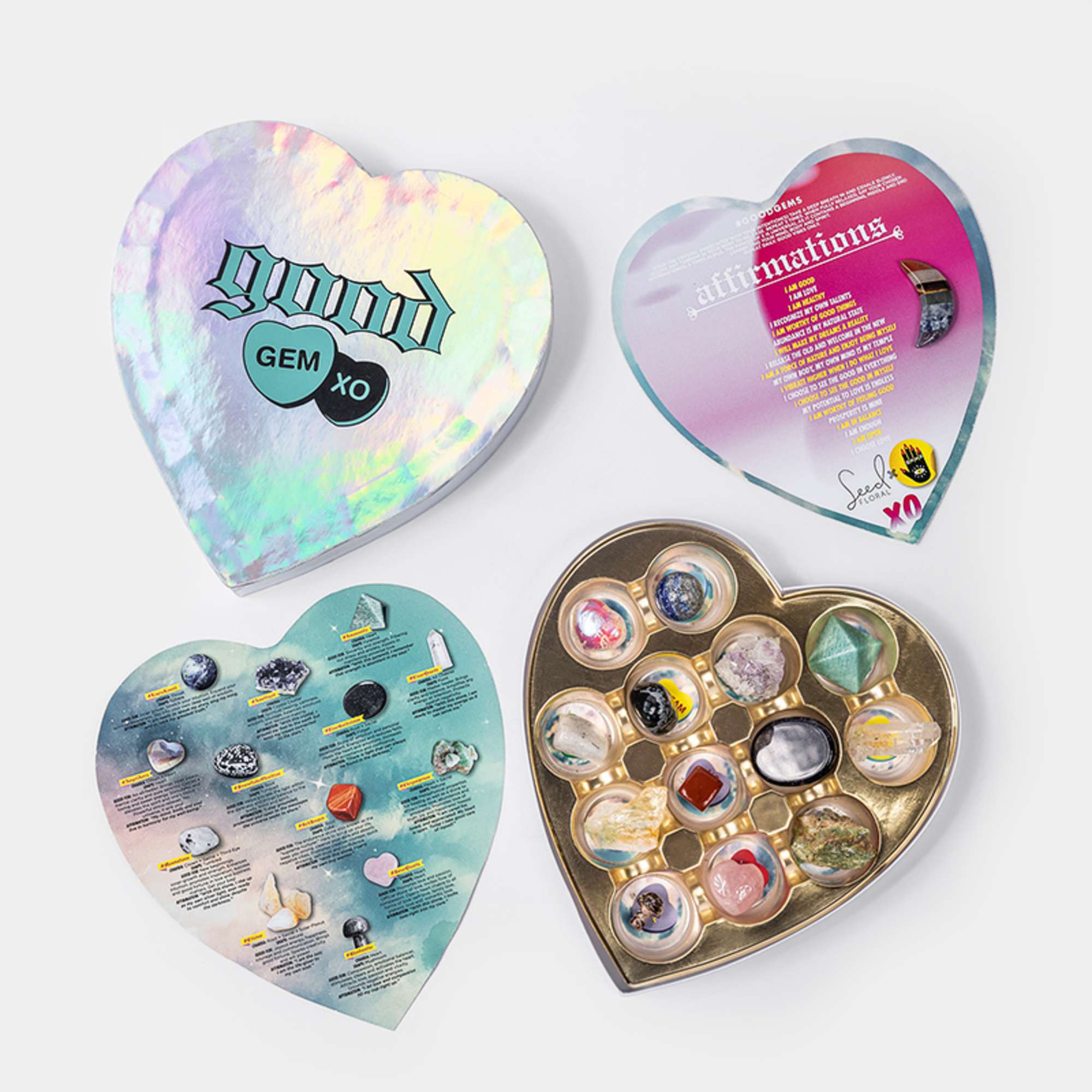 Four heart-shaped crystal gift boxes with colorful stones and printed inserts