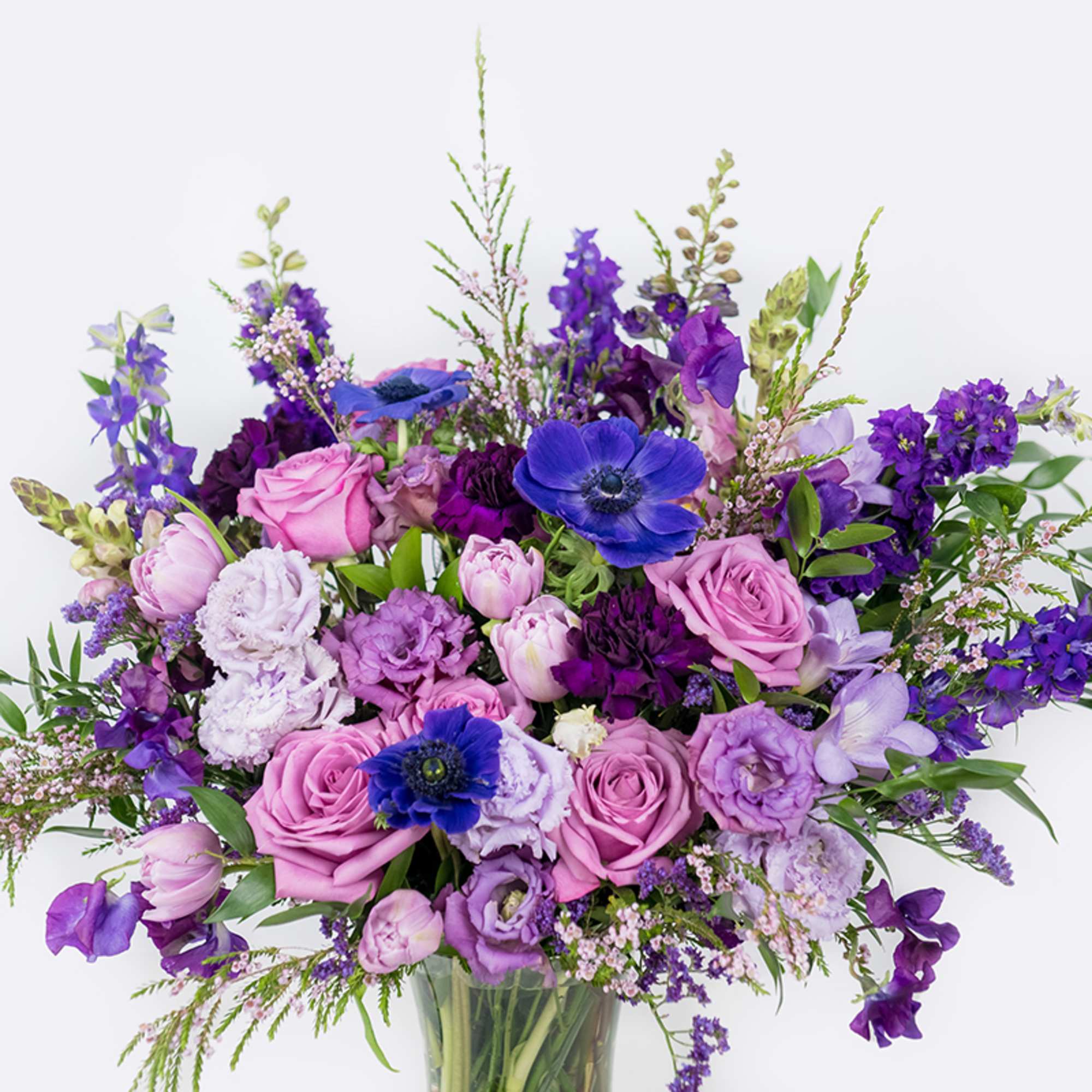 Purple and pink mixed bouquet in a glass vase