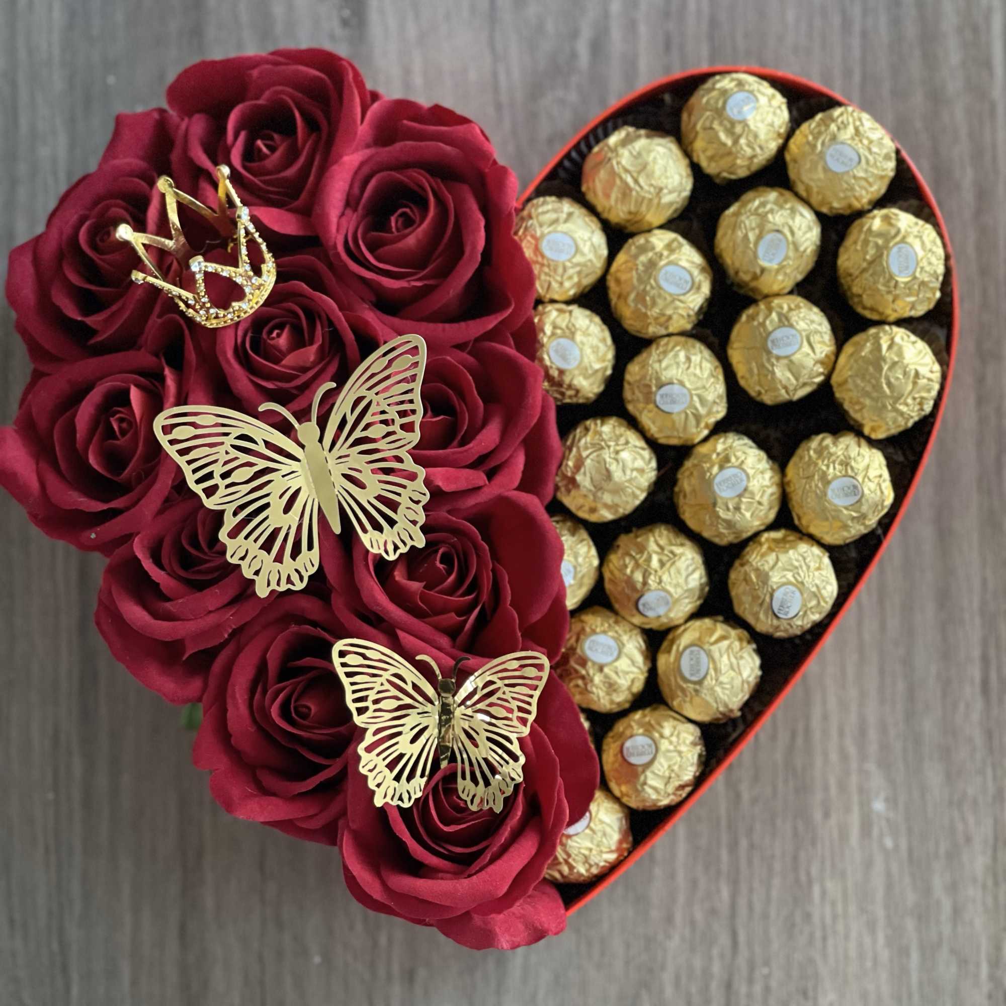 Heart-shaped box with red roses and gold-wrapped chocolates