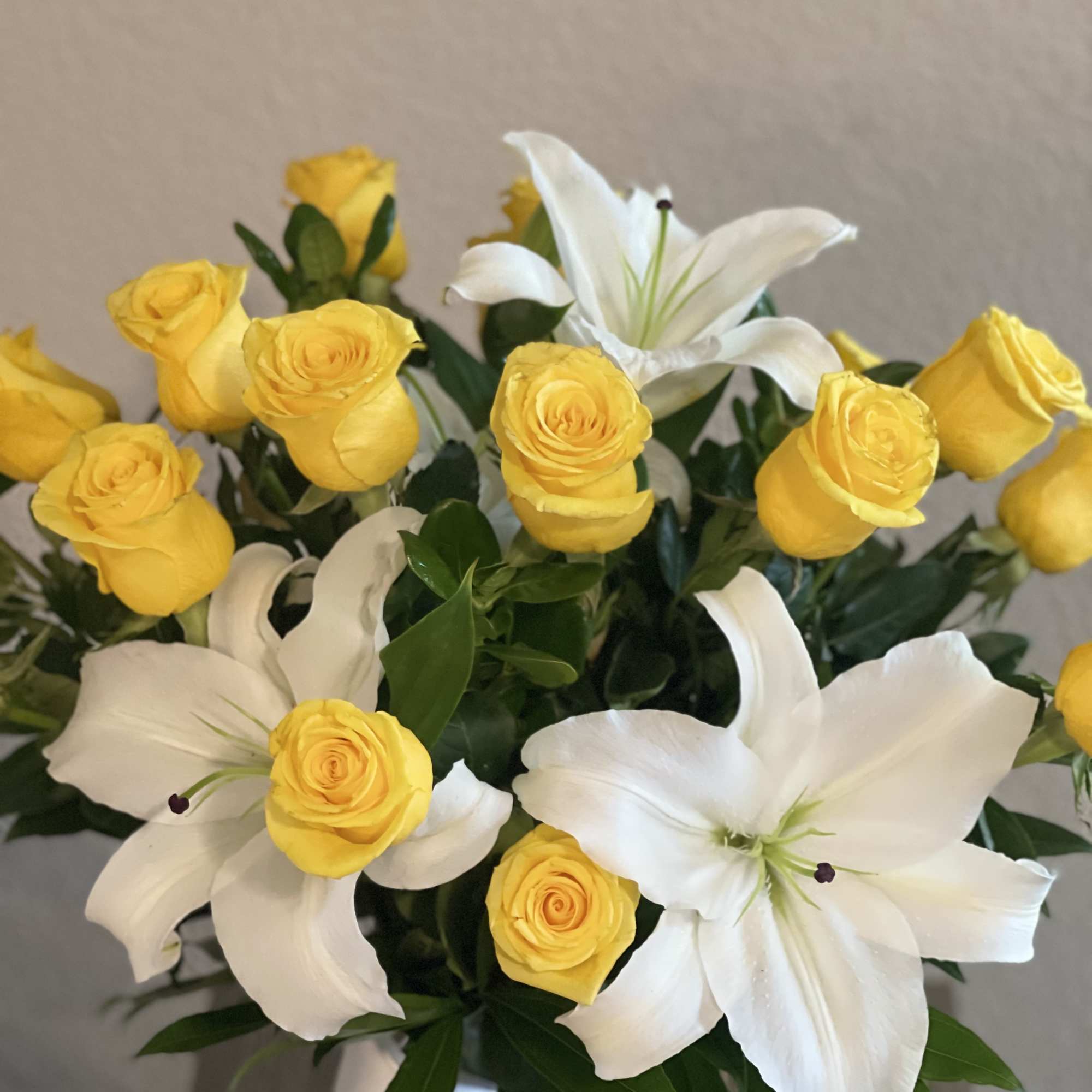 Yellow roses and white lilies in a bouquet