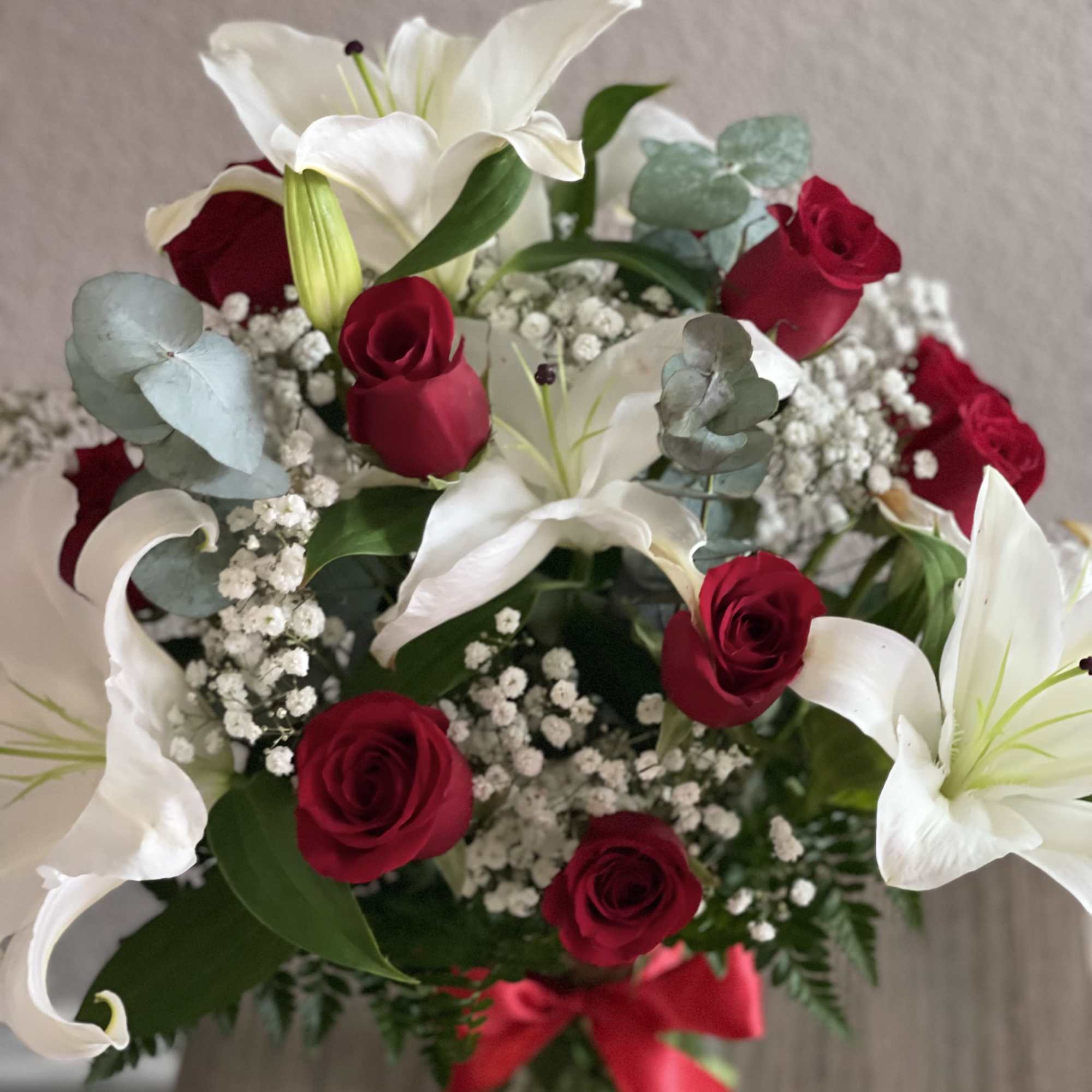 Bouquet of red roses and white lilies with baby's breath