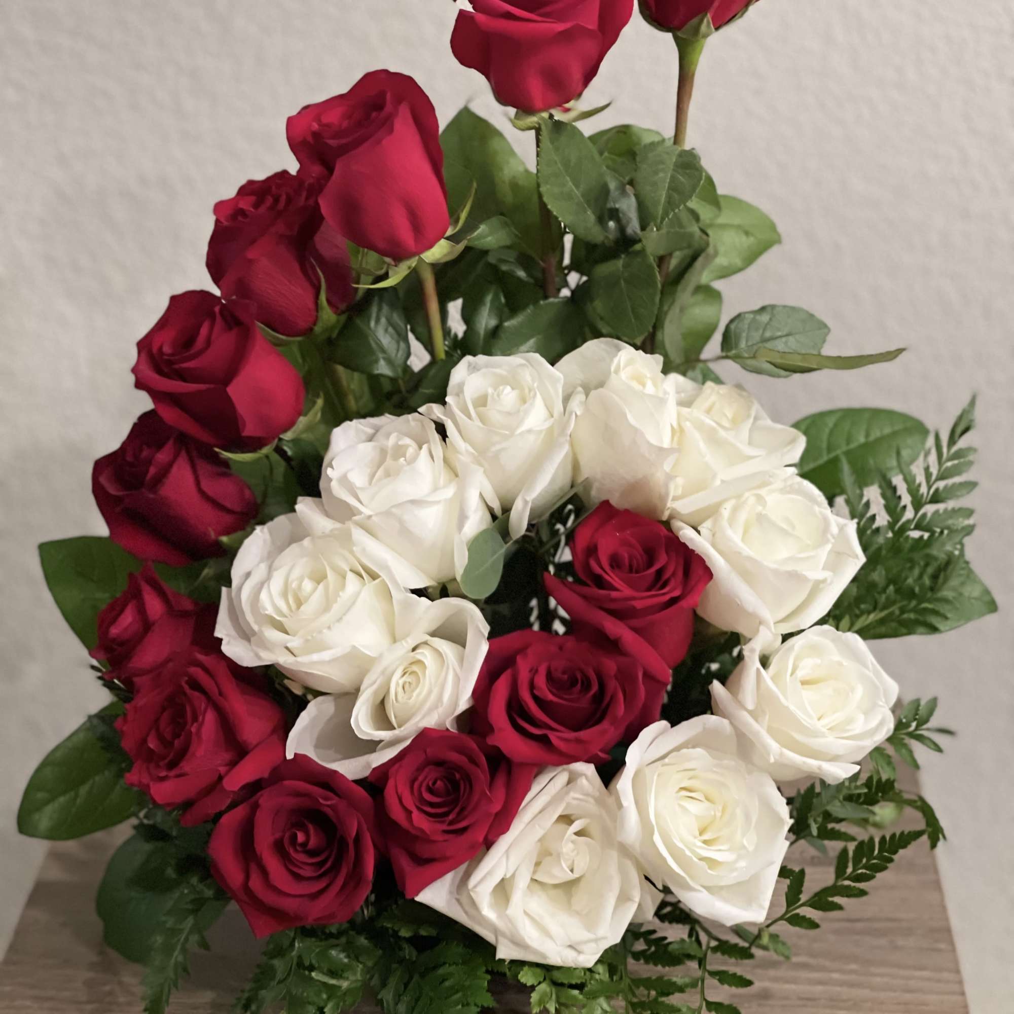 Red and white roses arranged in a vase