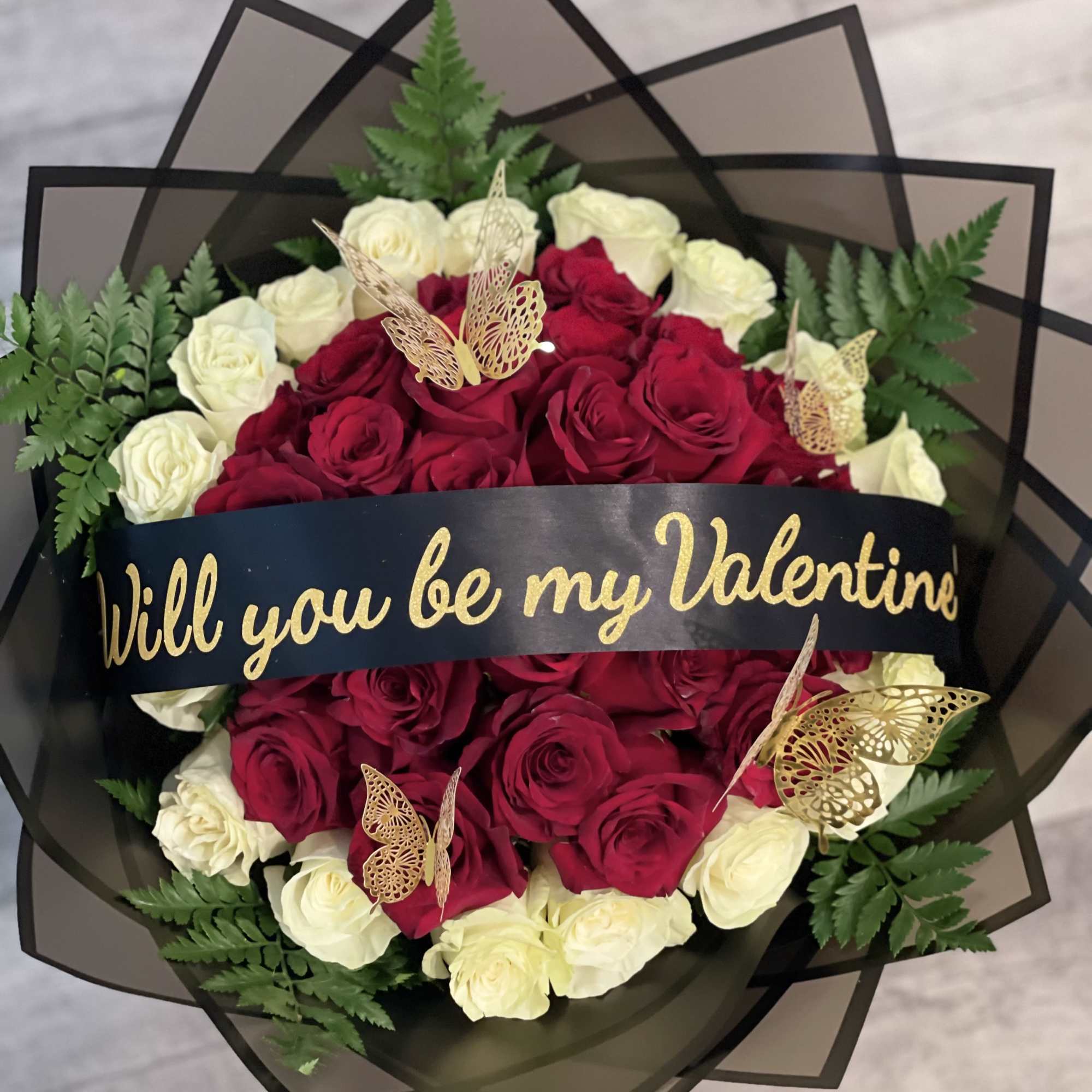 Bouquet of red and white roses with a Valentine ribbon