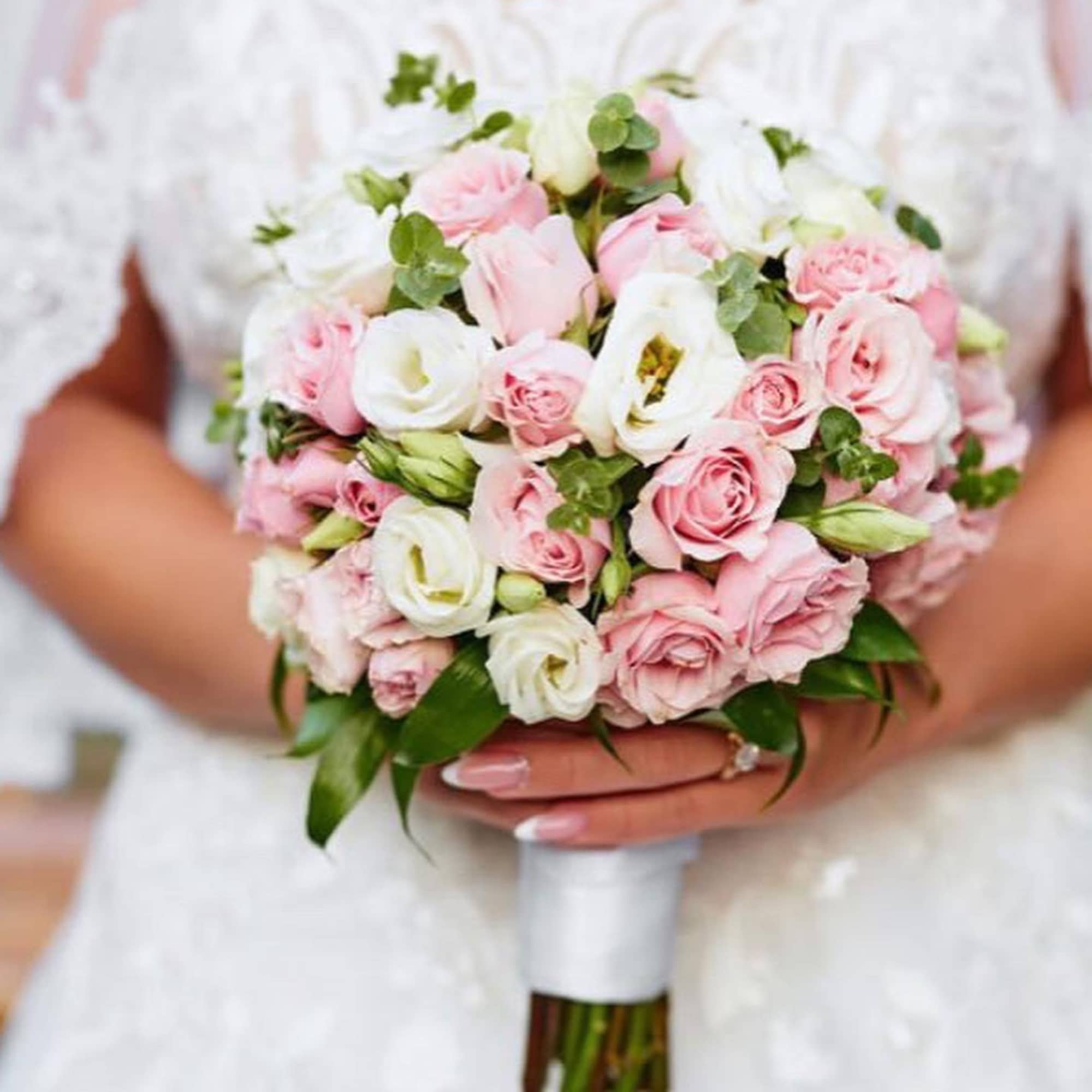 Bride holding a bouquet of pink and white roses