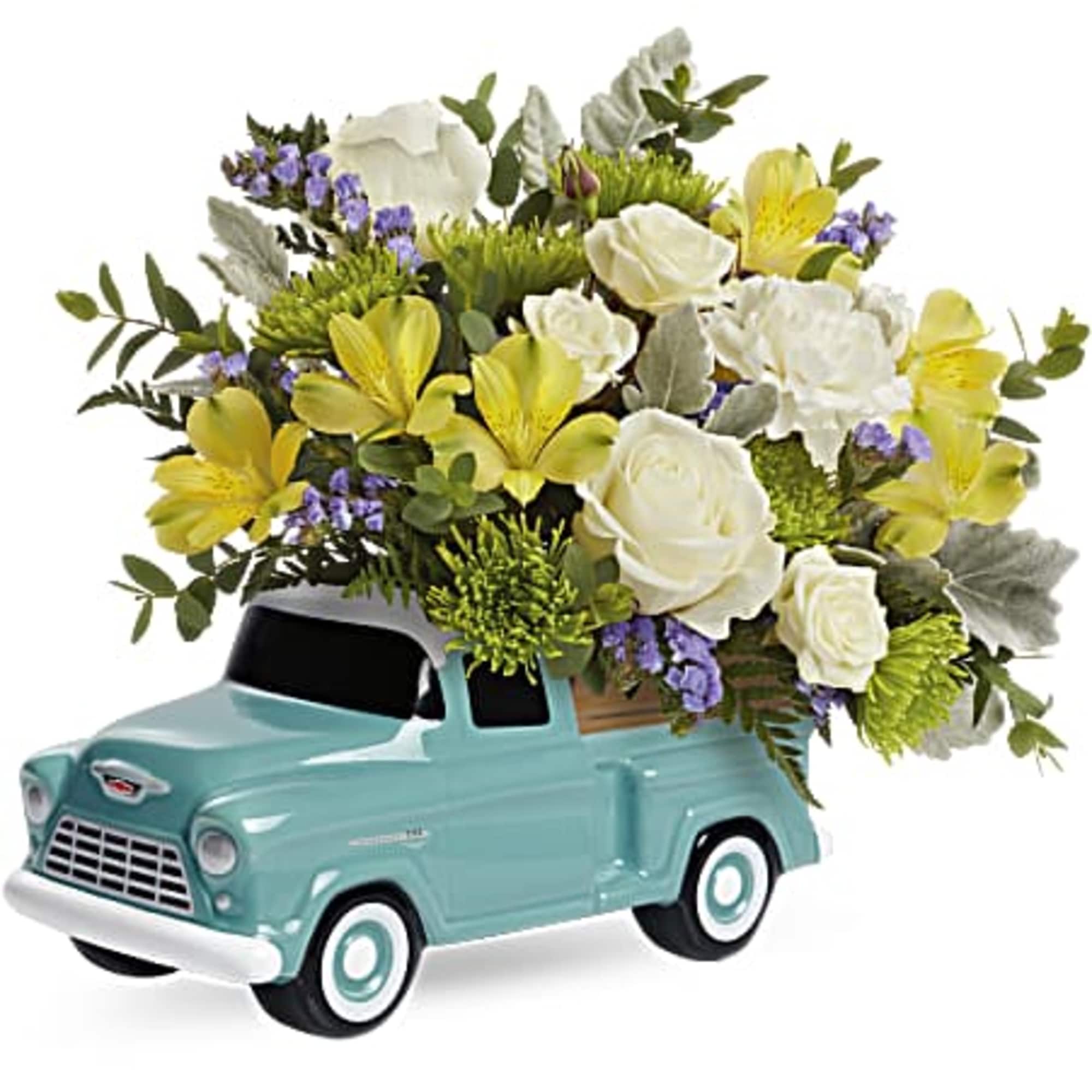 Flower arrangement in a turquoise vintage truck container