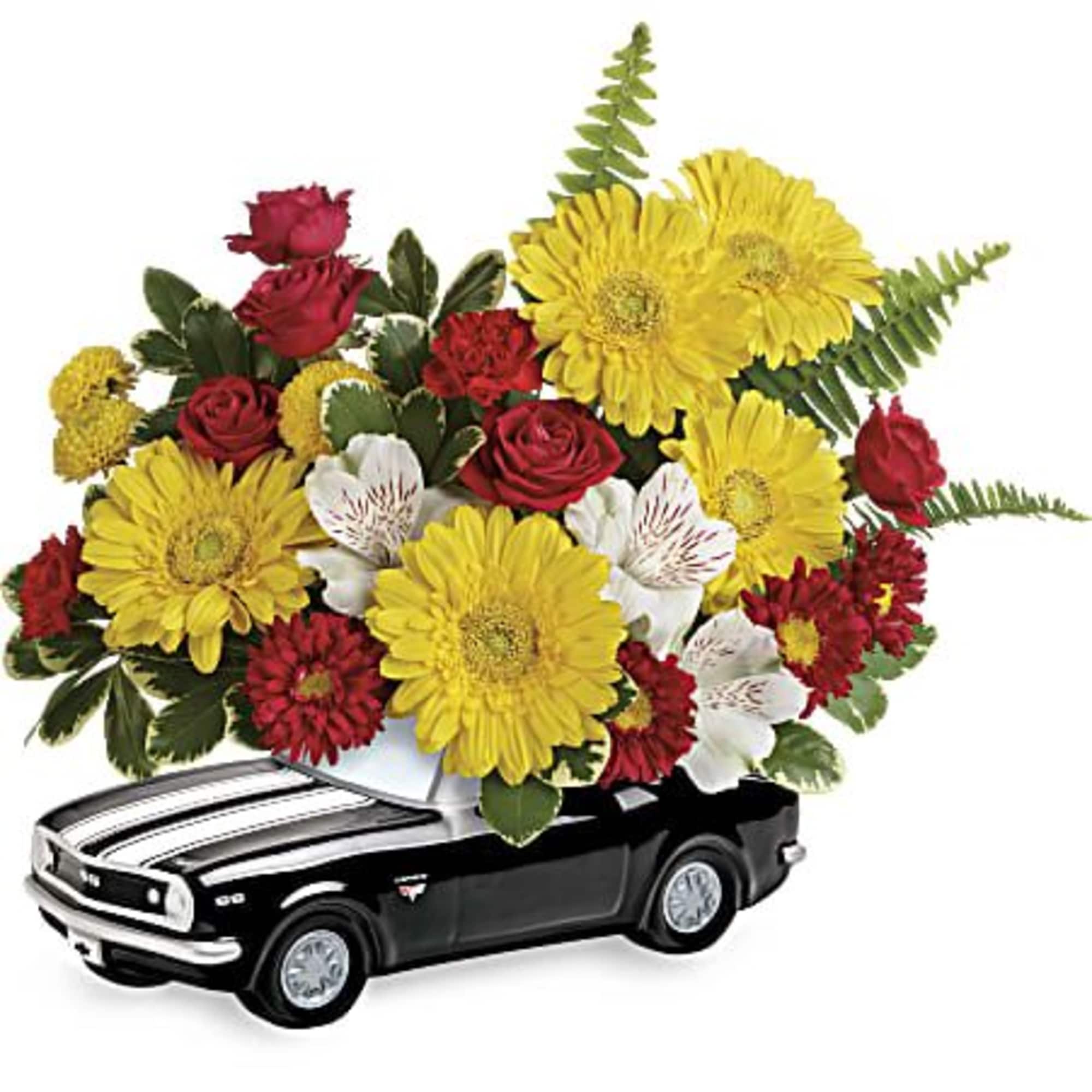 Flower arrangement in a black toy car container with yellow, red, and white blooms
