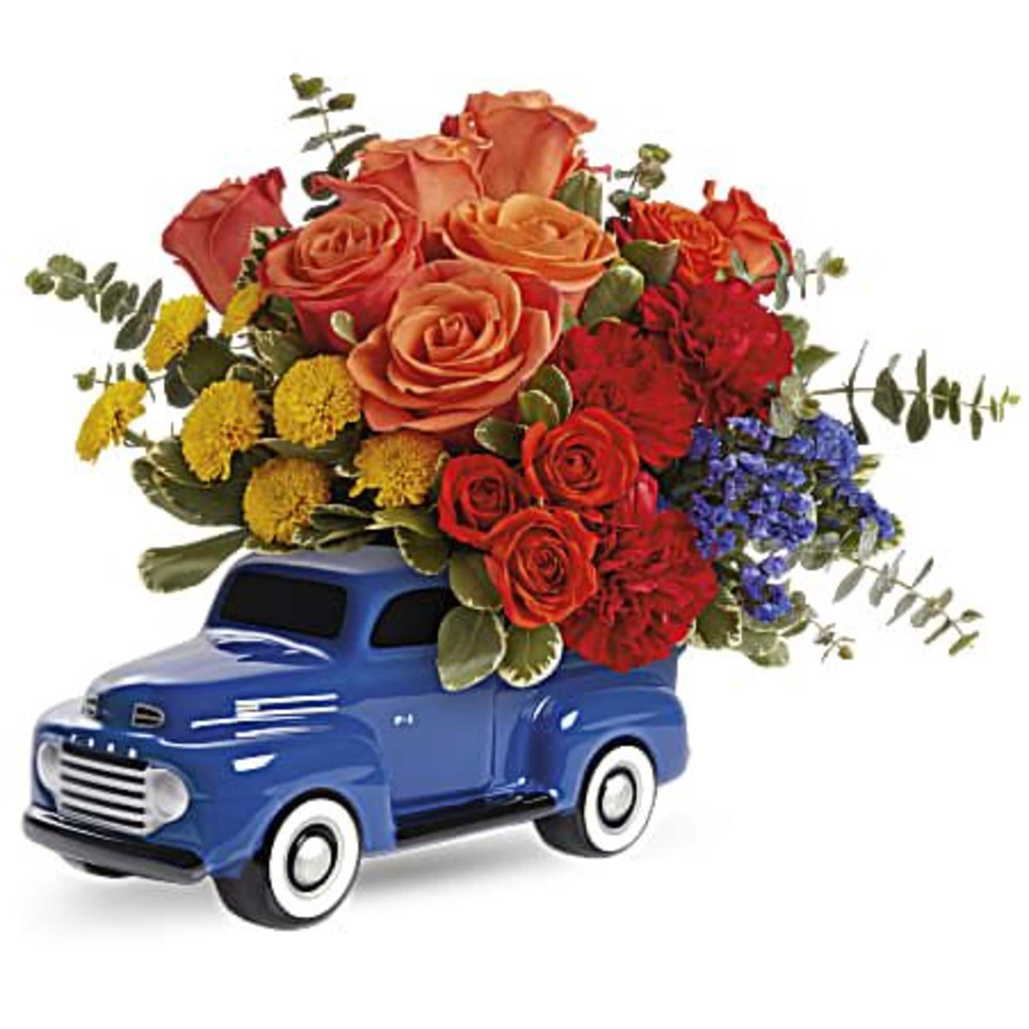 Bouquet of orange and red flowers arranged in a blue toy truck