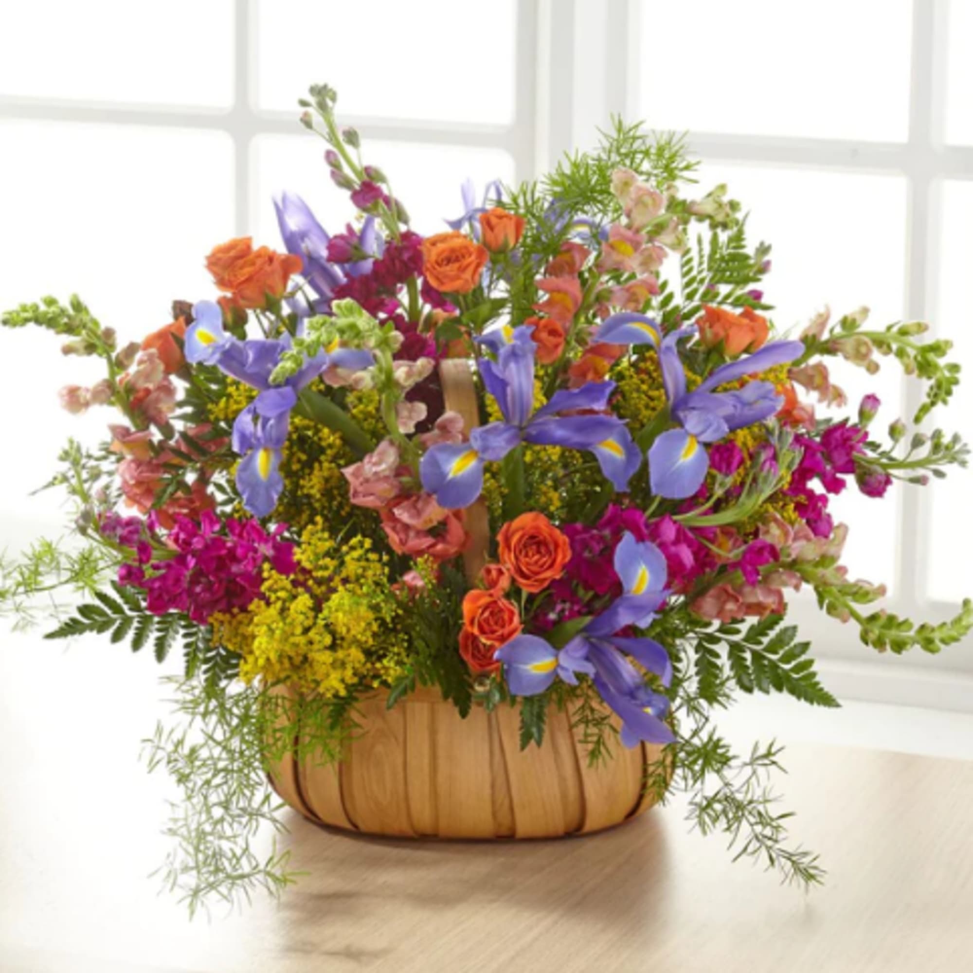 Colorful mixed flower arrangement in a pumpkin-shaped container
