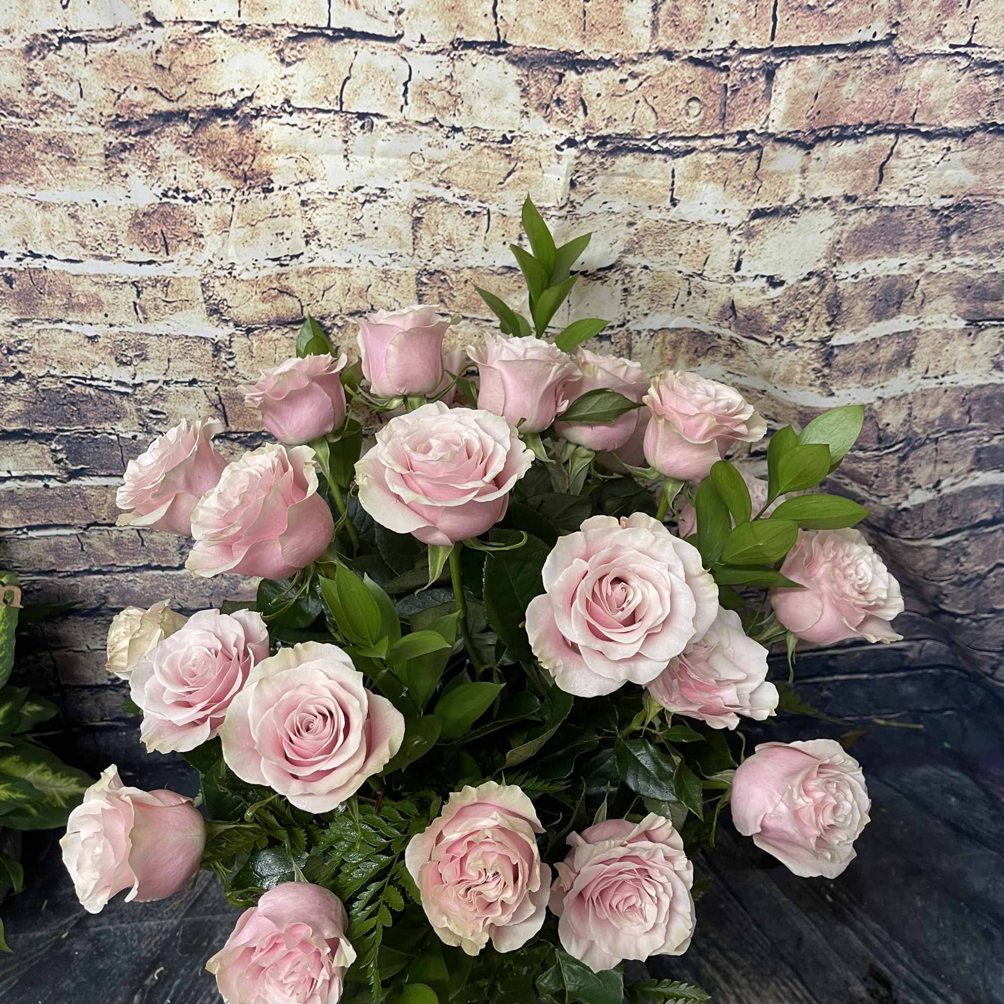 Bouquet of pale pink roses with green foliage