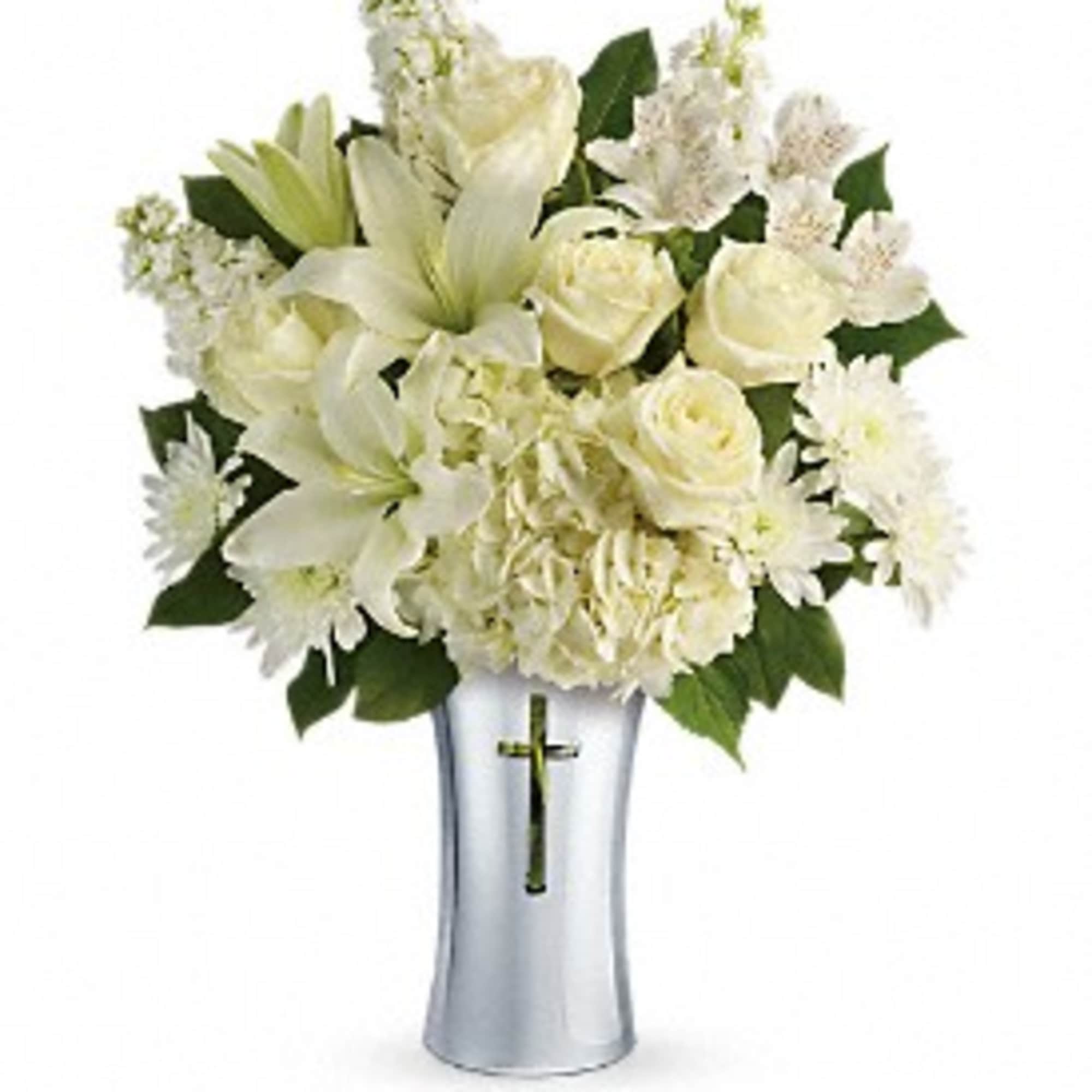 White floral arrangement in a silver vase with a cross emblem