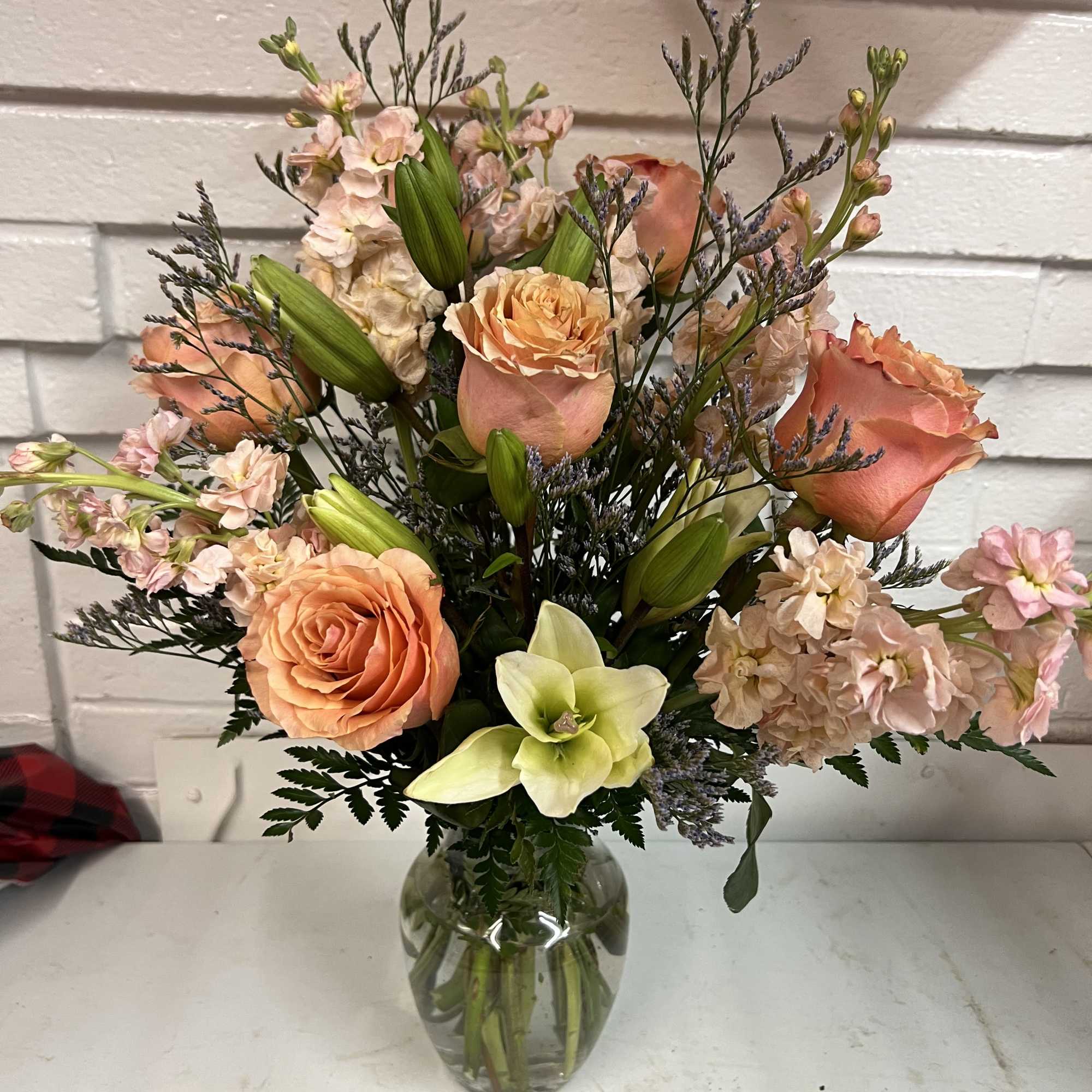 What&rsquo;s pretty in peach? This rich mix of orange lilies, peach roses, photo 2 of 3
