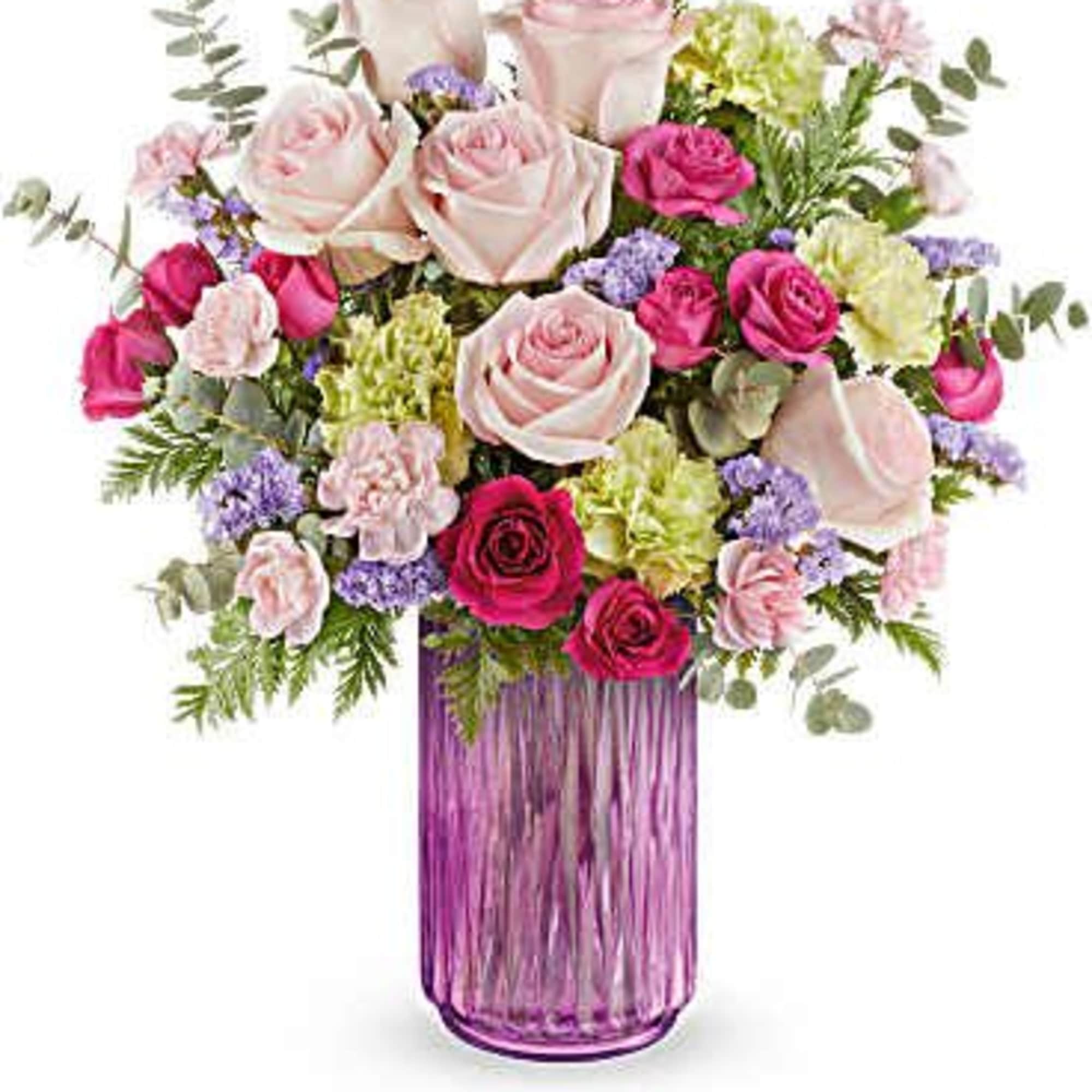 Pink and white roses in a purple glass vase