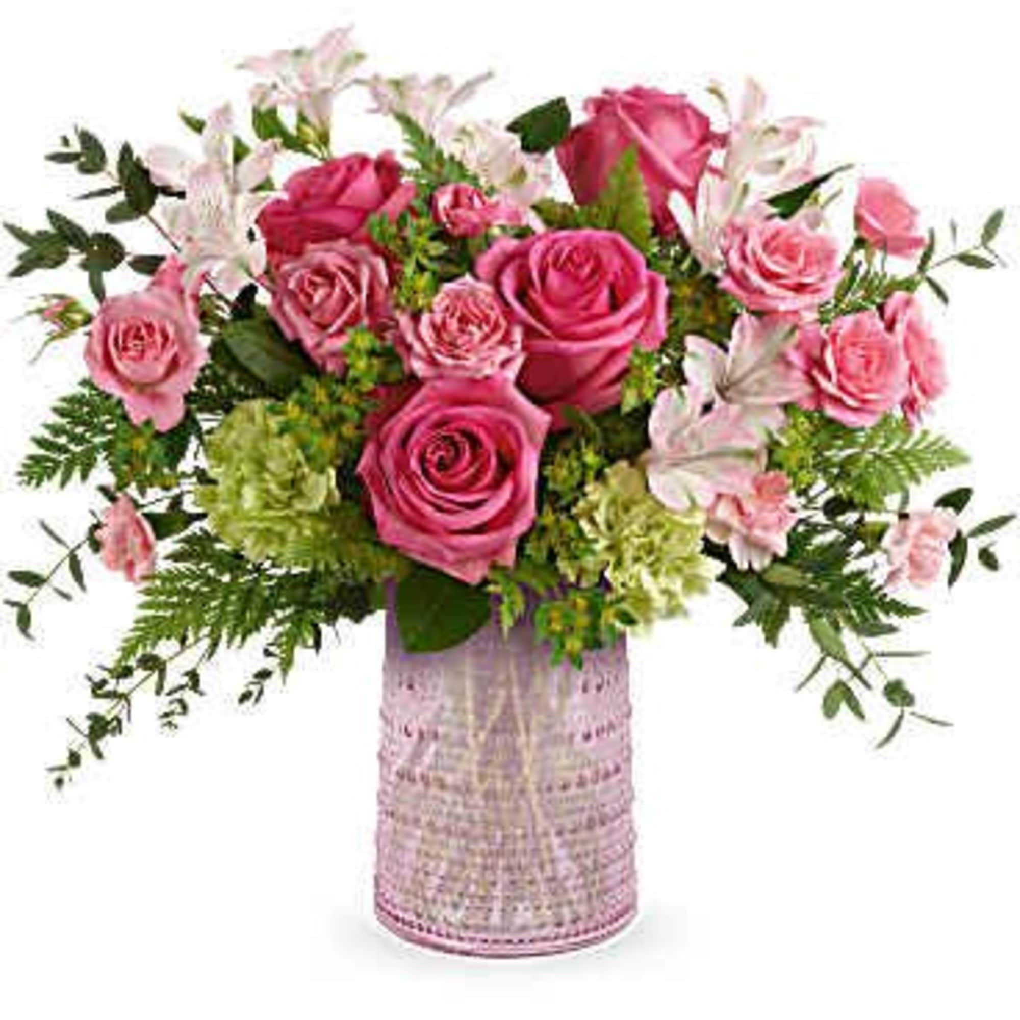 Pink roses and lilies arranged in a pink vase