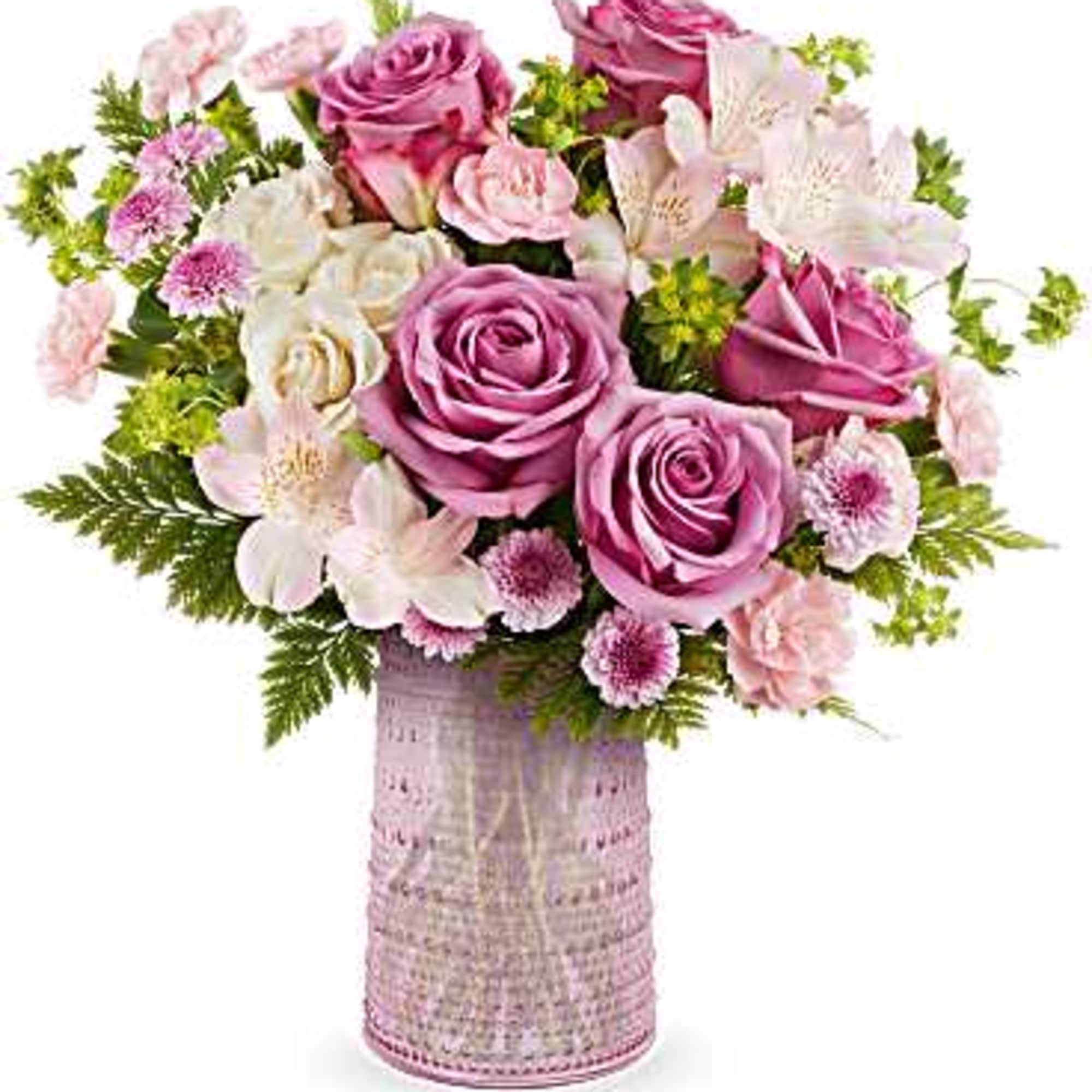 Pink and white rose bouquet in a textured vase