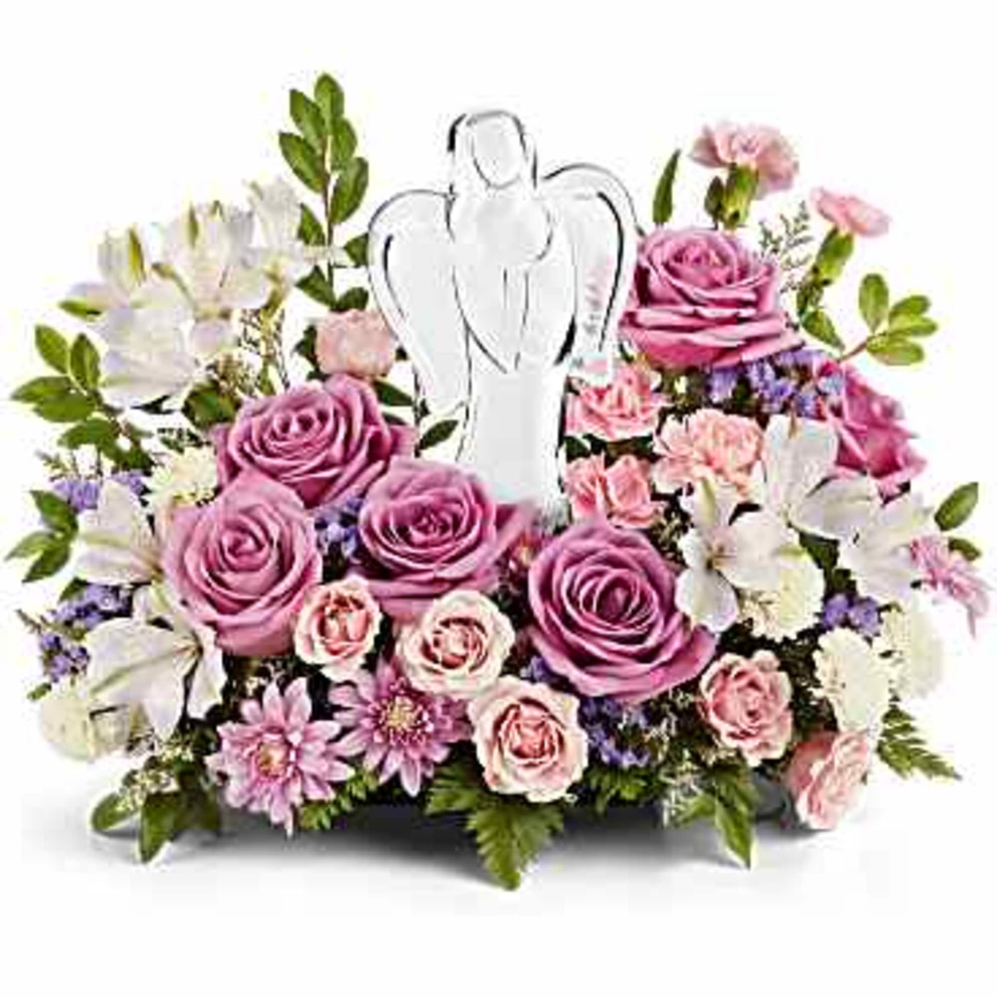 Pink and white floral arrangement with an angel pick