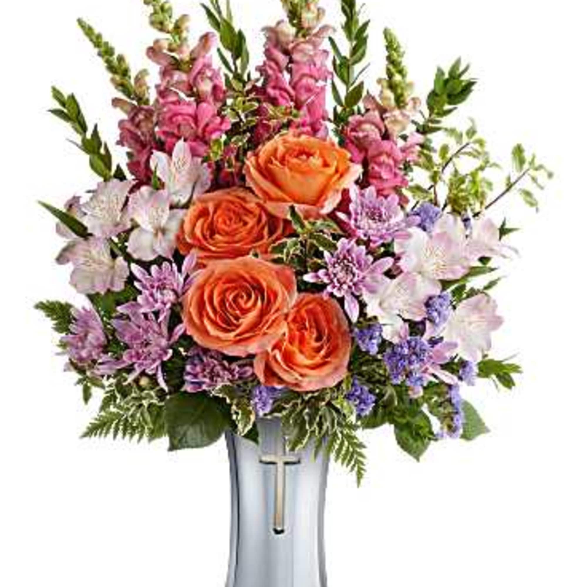 Orange roses and purple flowers in a silver vase
