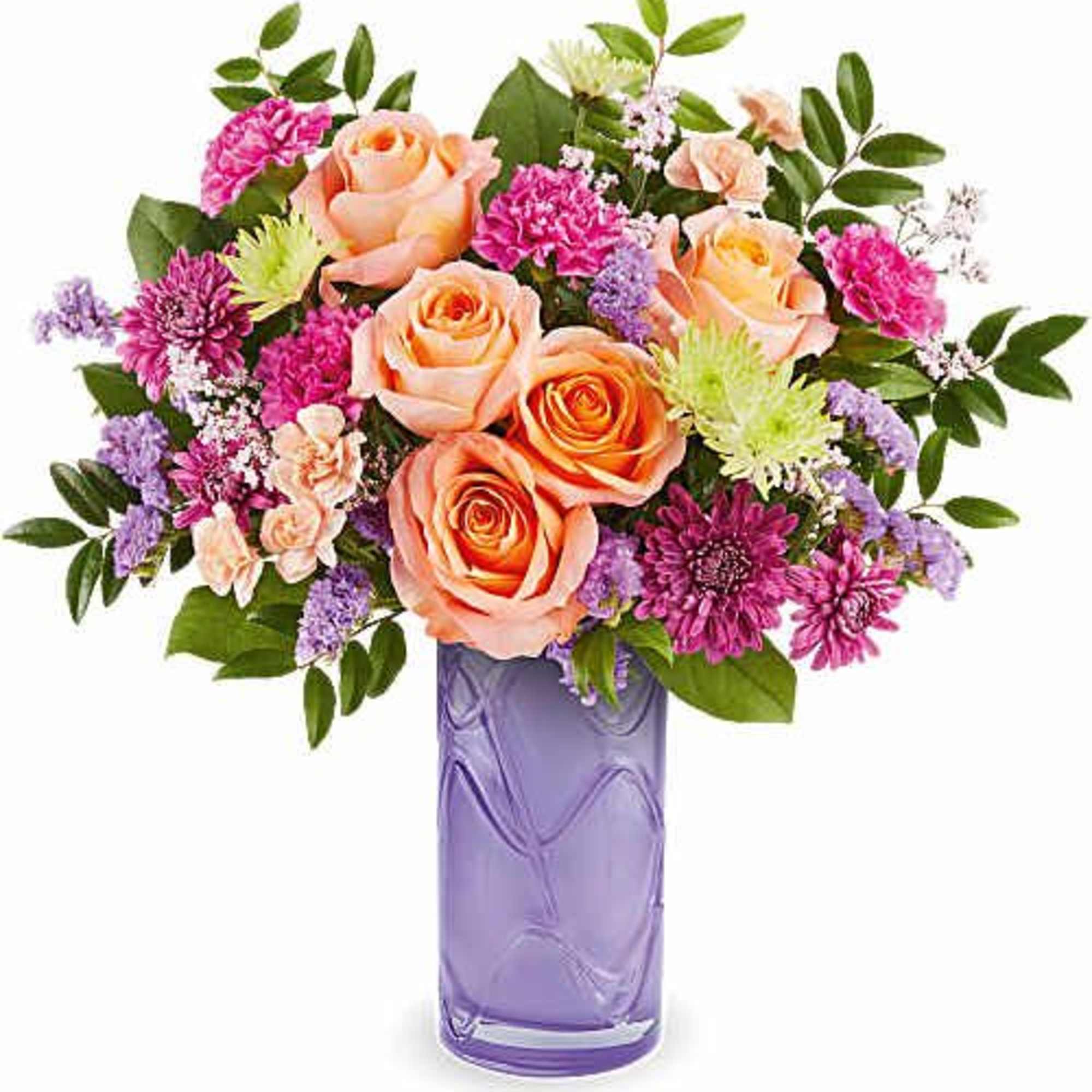 Peach roses and purple flowers in a lavender glass vase