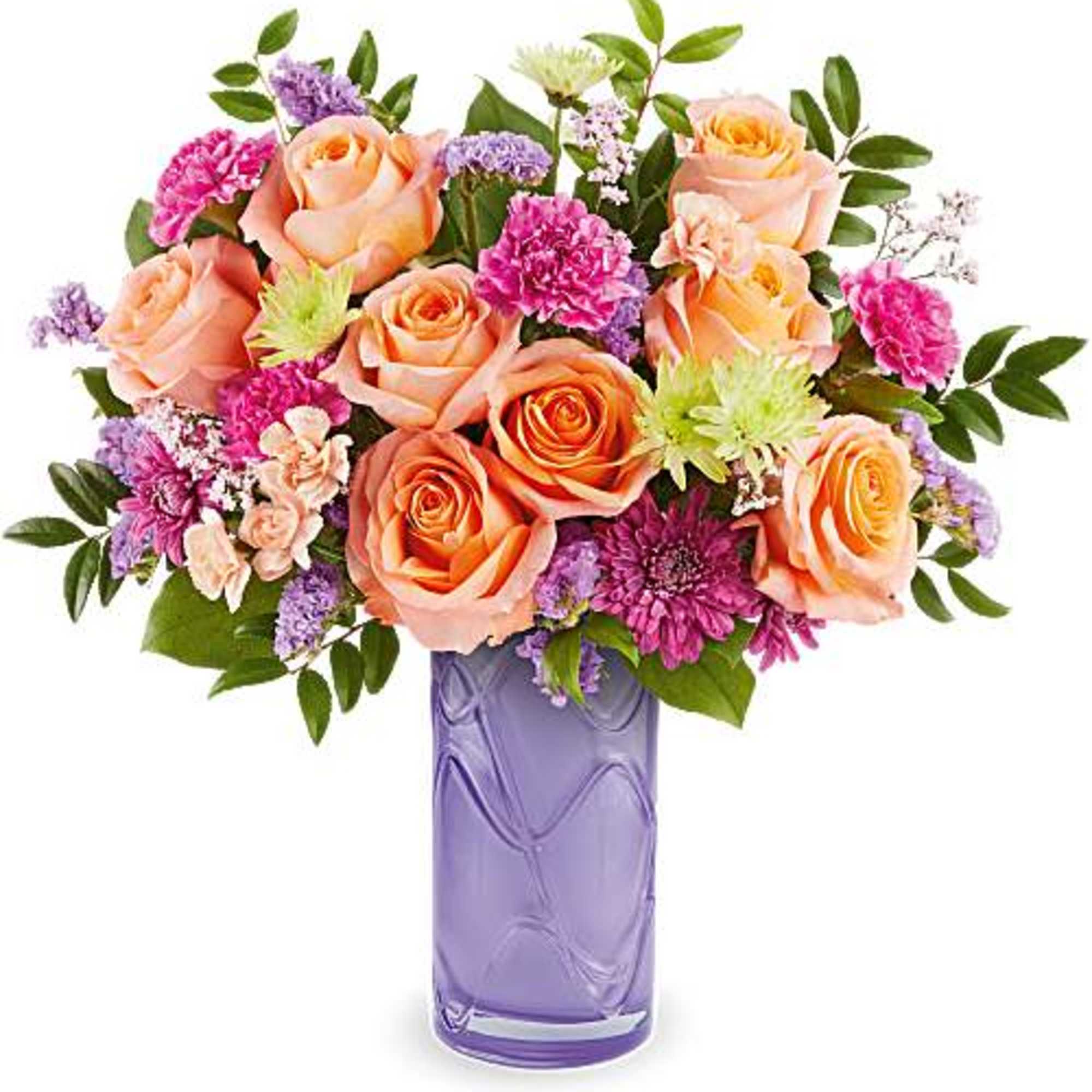 Peach roses and purple flowers in a lavender vase