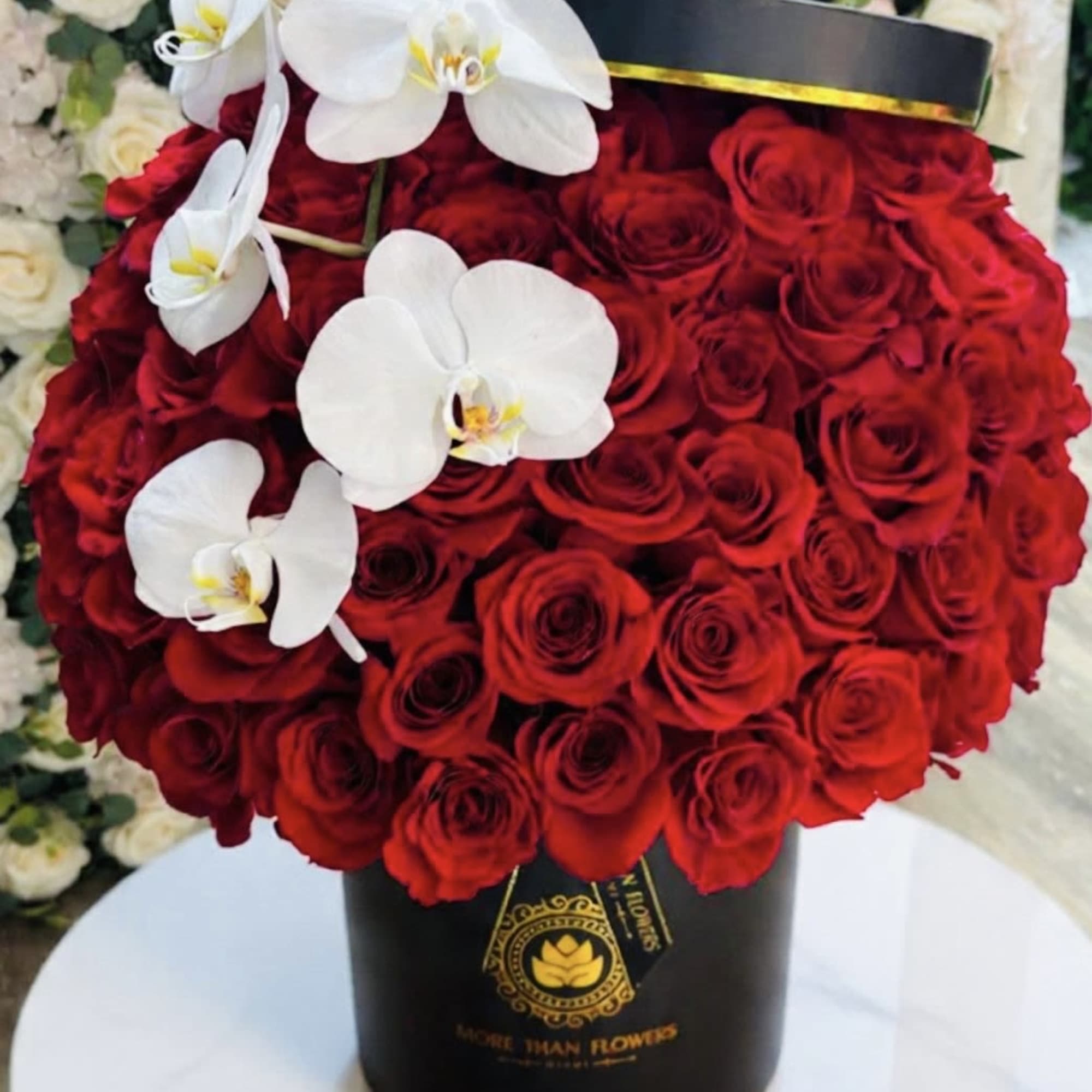 75 Roses in a our signature boxes accented with phalaenopsis orchids, photo 3 of 3