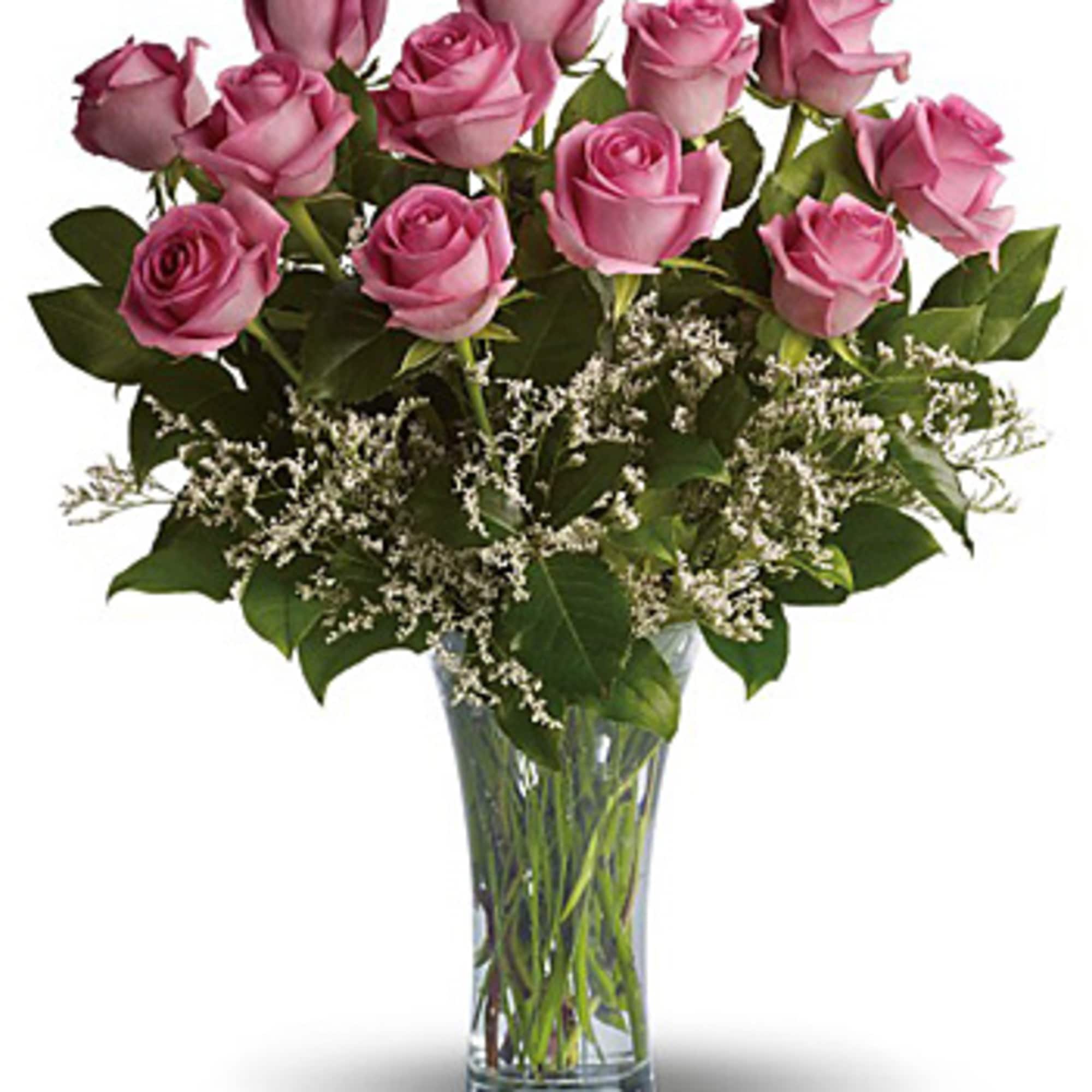 Pink roses arranged in a clear glass vase