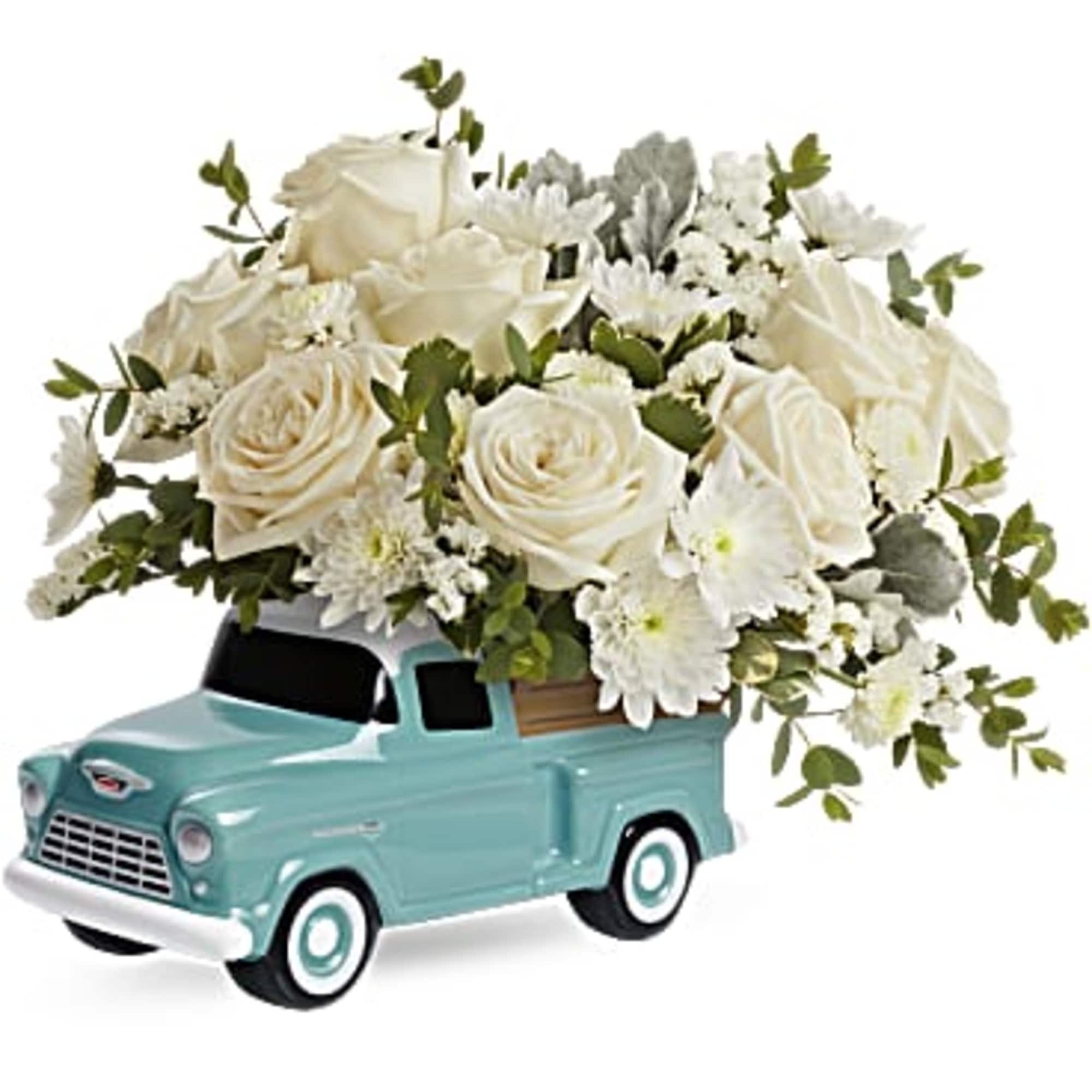 White rose bouquet arranged in a turquoise toy truck