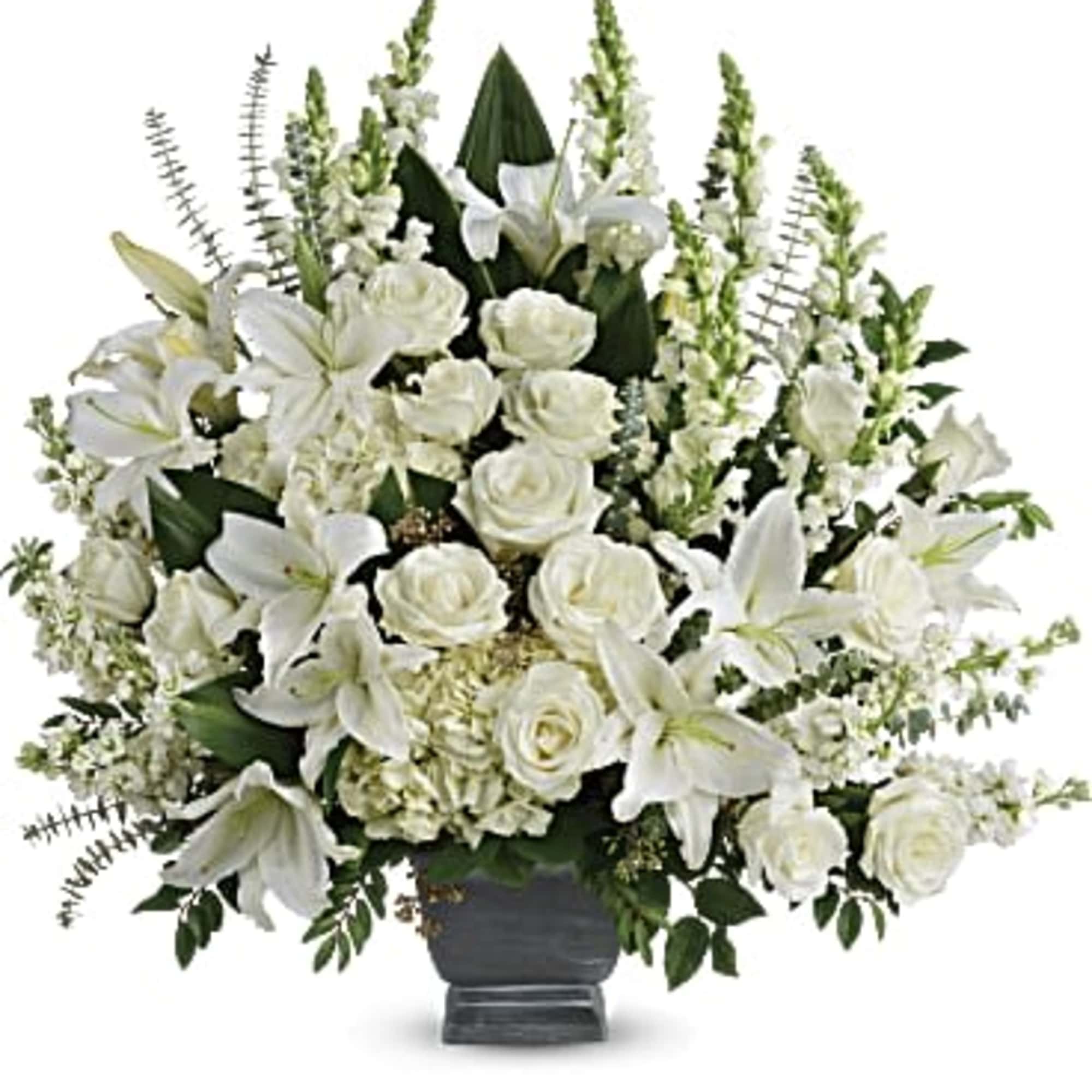 White lilies and roses arranged in a dark vase