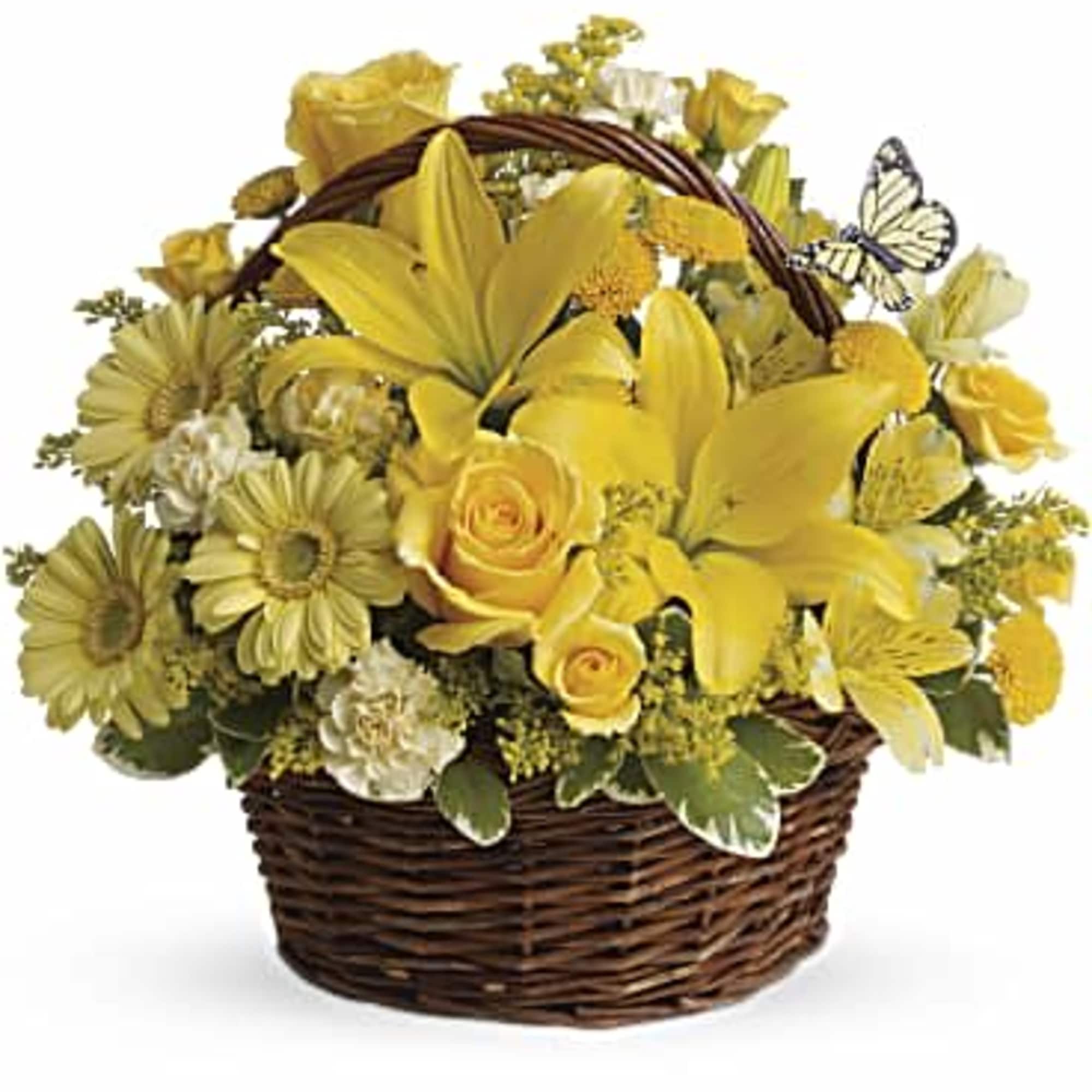 Yellow flowers arranged in a wicker basket with a butterfly accent