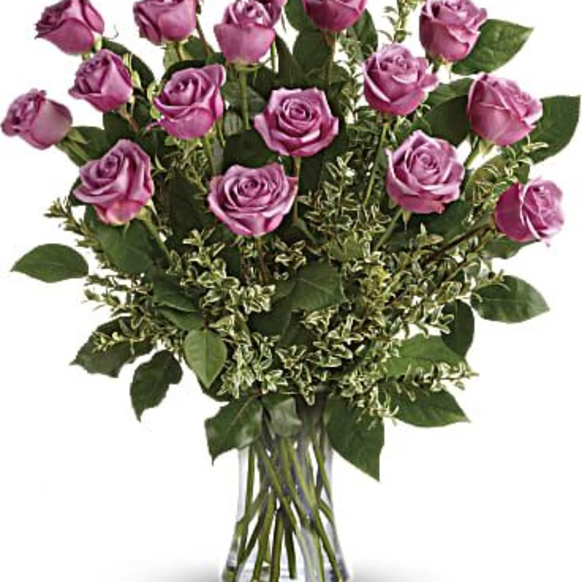 Bouquet of purple roses in a clear glass vase