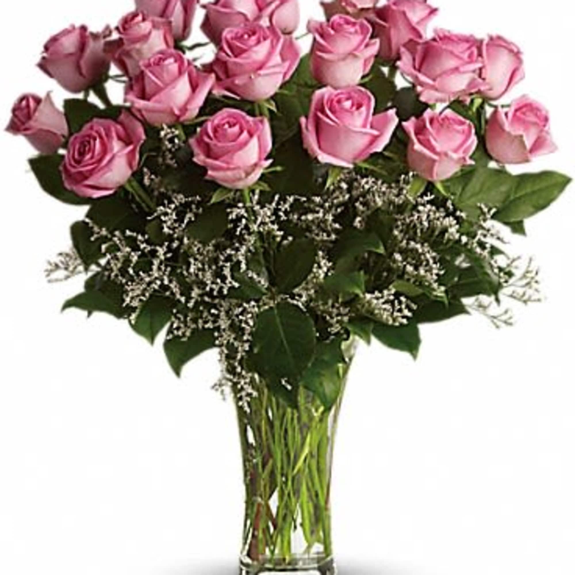 Pink roses arranged in a clear glass vase