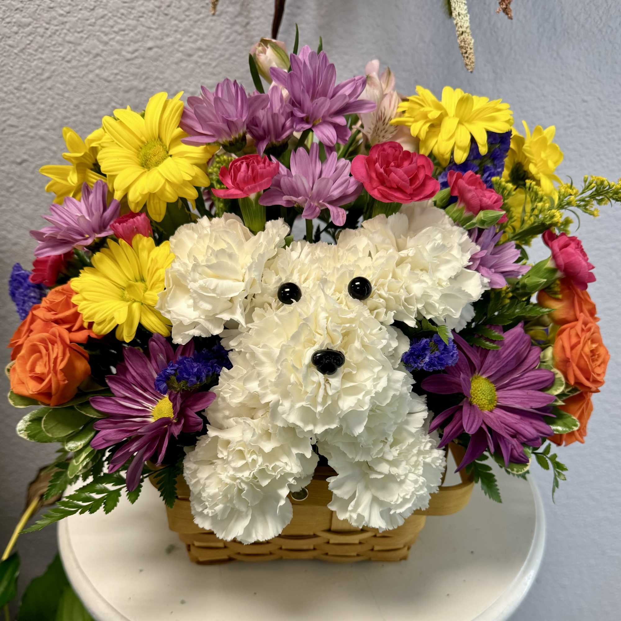 Colorful flower basket arranged like a white teddy bear face