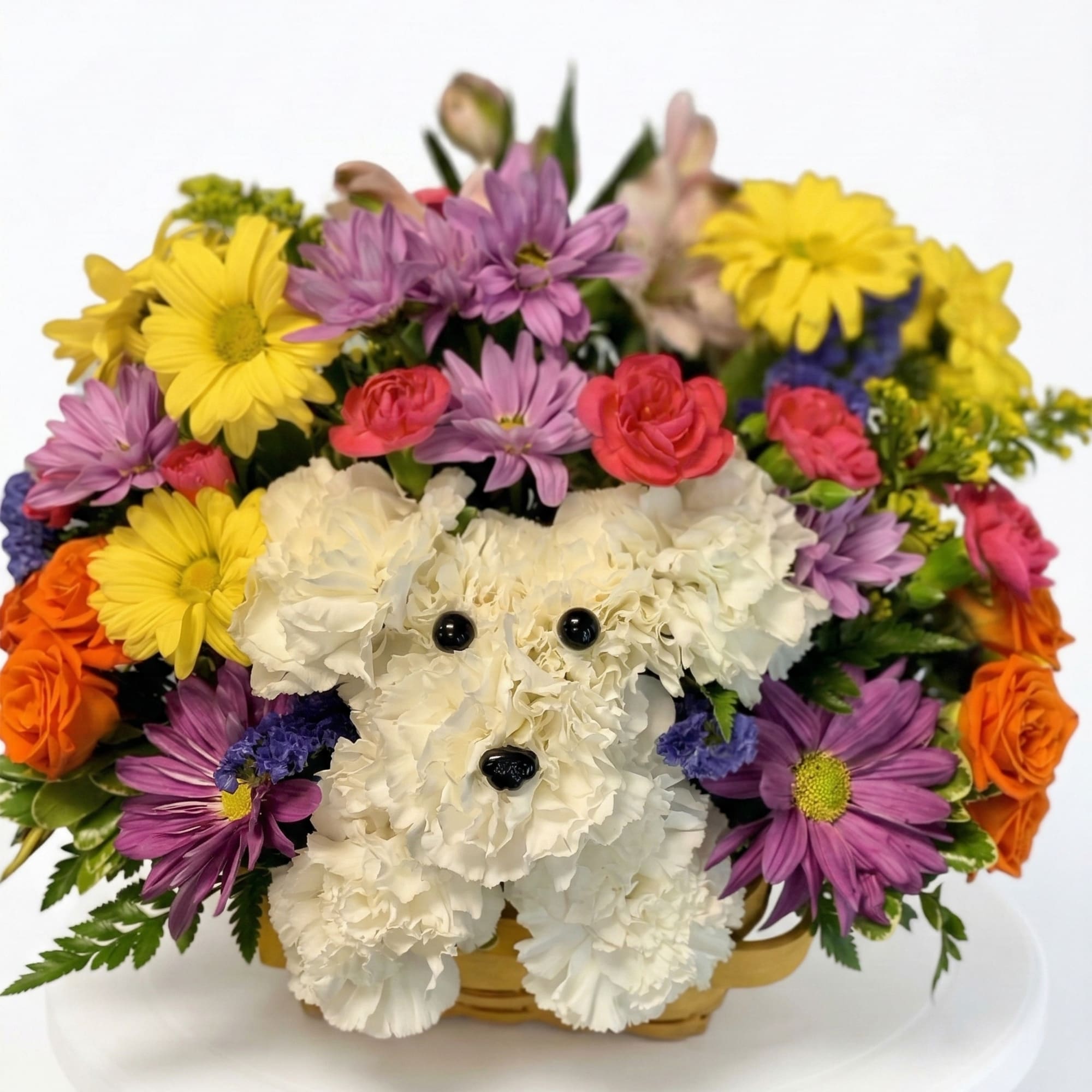 White teddy bear made of flowers in a basket with colorful blooms