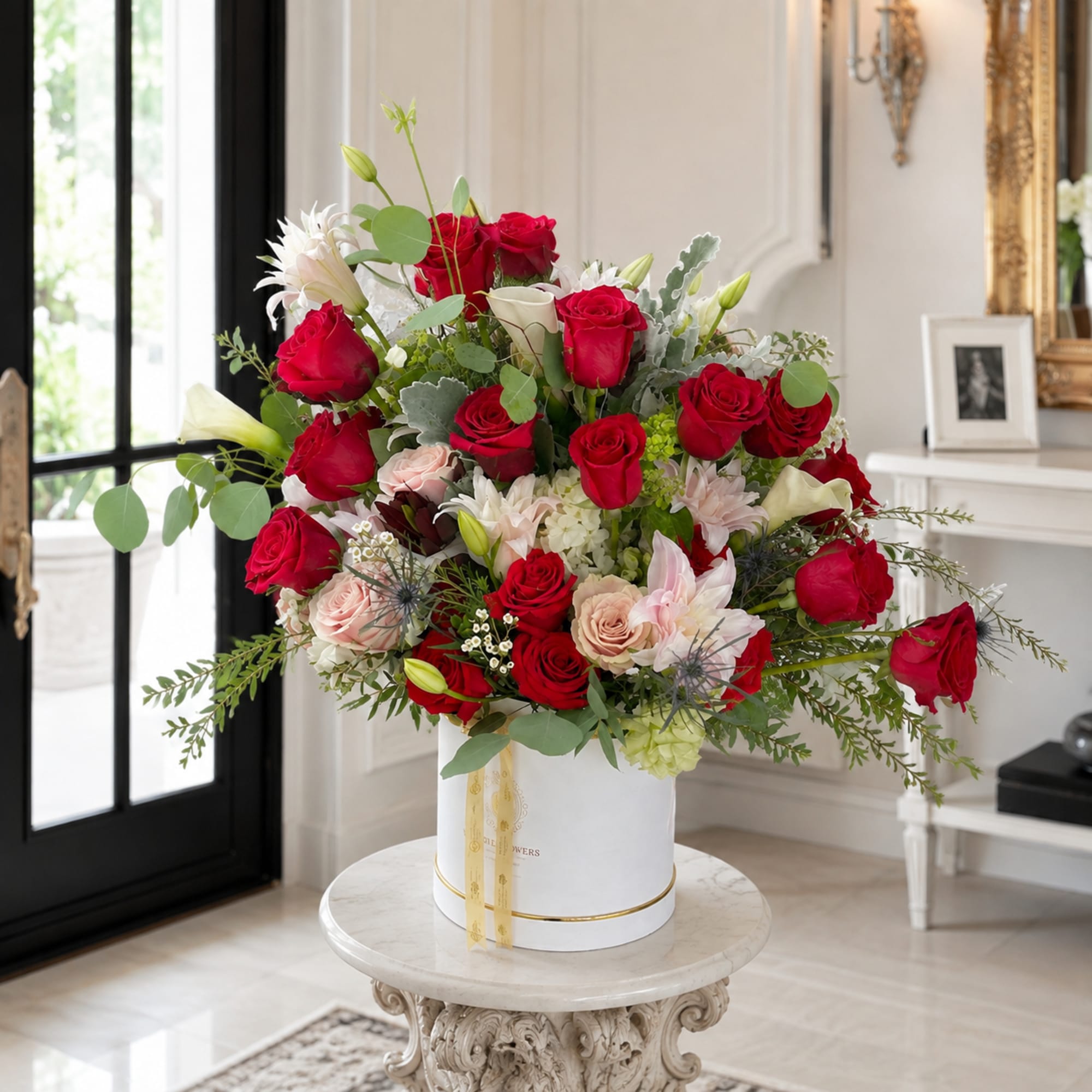 Large bouquet of red and blush roses in a white hat box