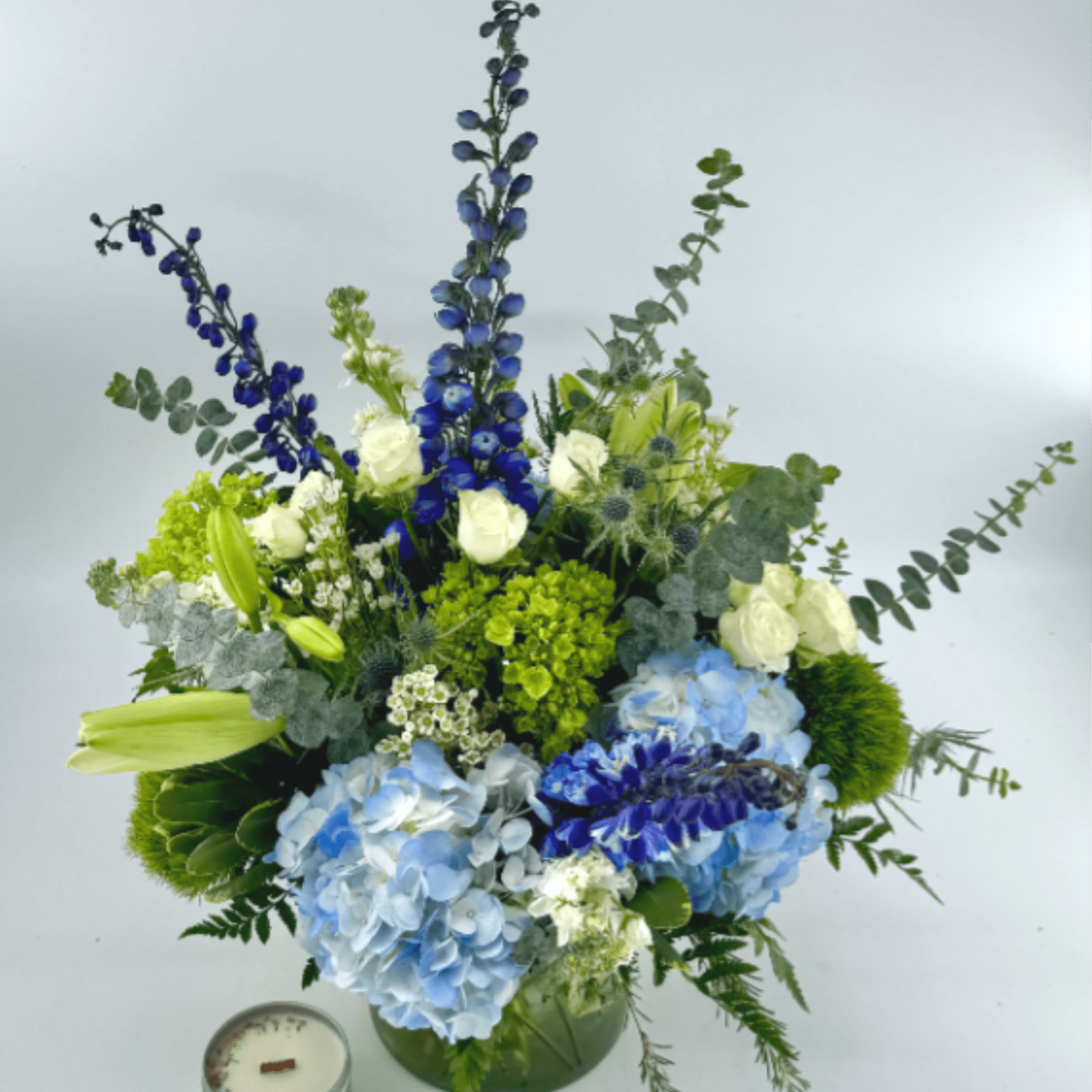 Ocean Mist blends blue hybrid delphinium, blue-green hydrangea, white stock and lilies