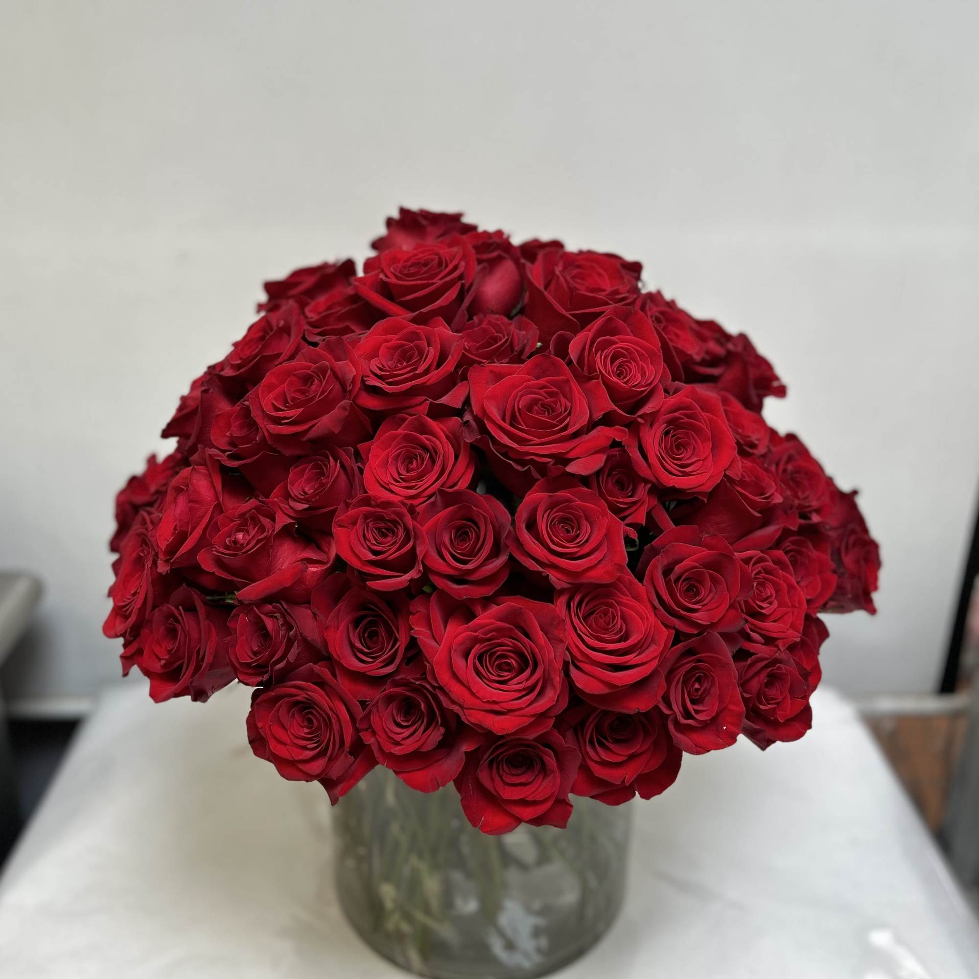 Bouquet of red roses in a glass vase