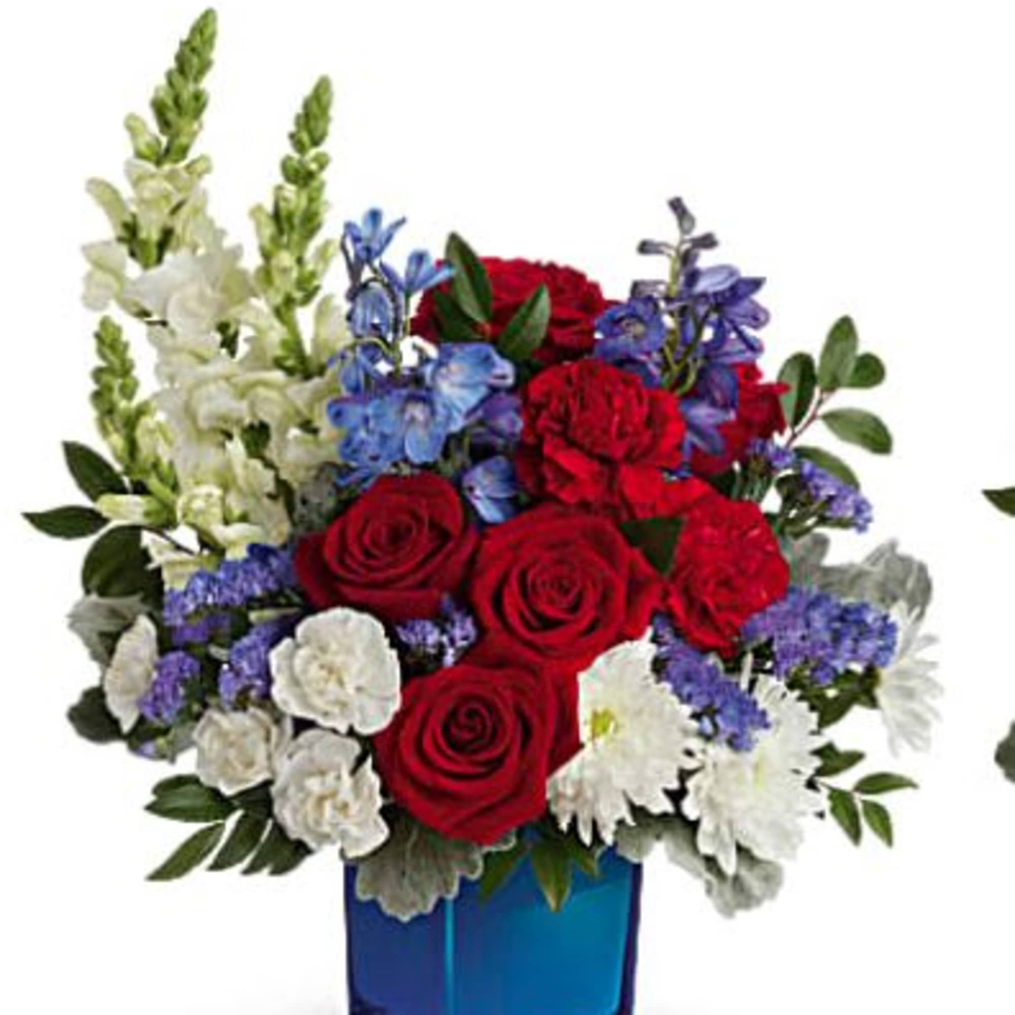 Red roses, white flowers, and blue blooms in a blue vase