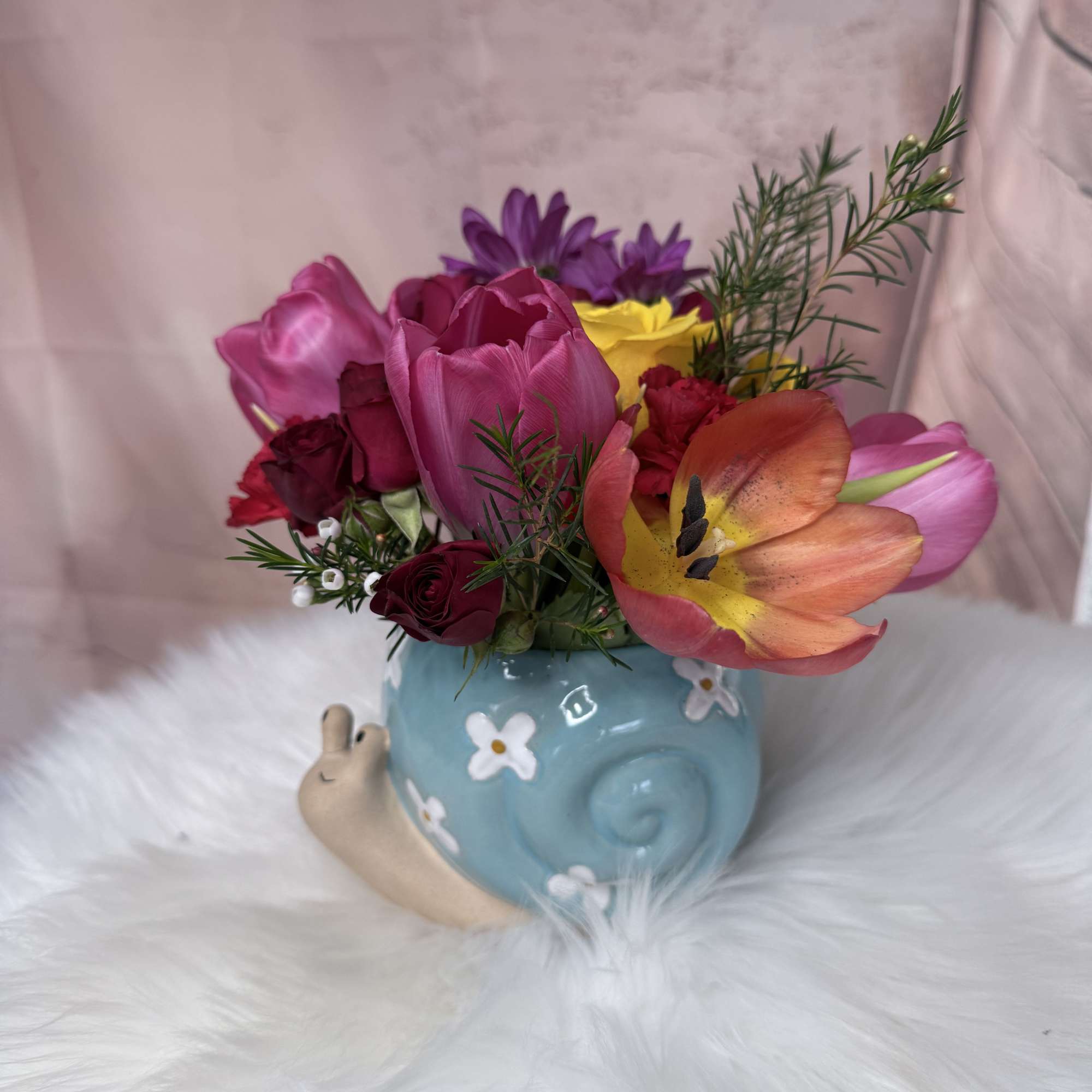 A sweet and charming arrangement featuring delicate flowers and fresh seasonal foliage, photo 2 of 3