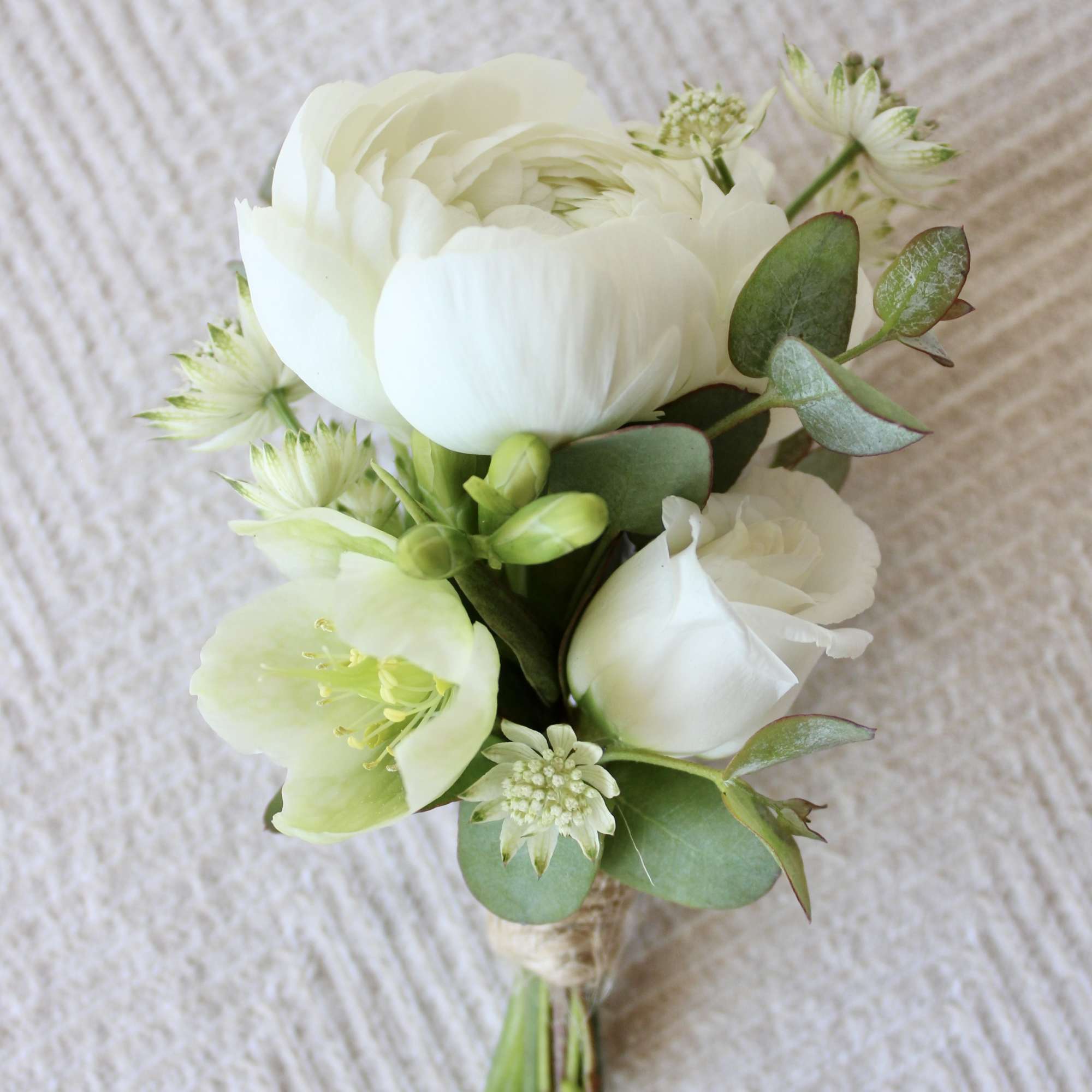 White flower bouquet with green accents and eucalyptus