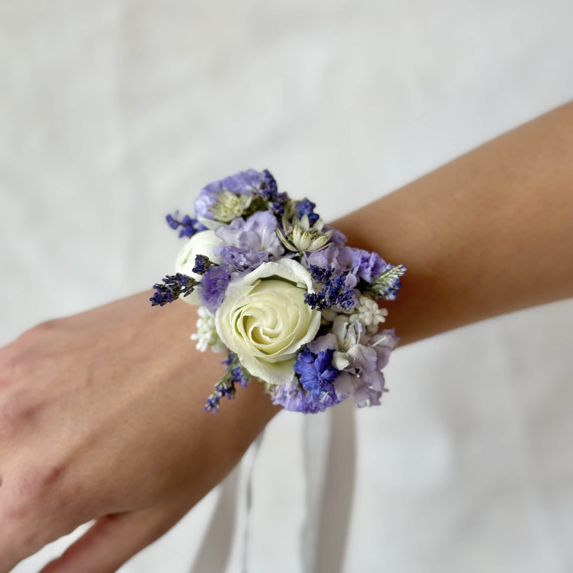 White rose wrist corsage with lavender and purple flowers