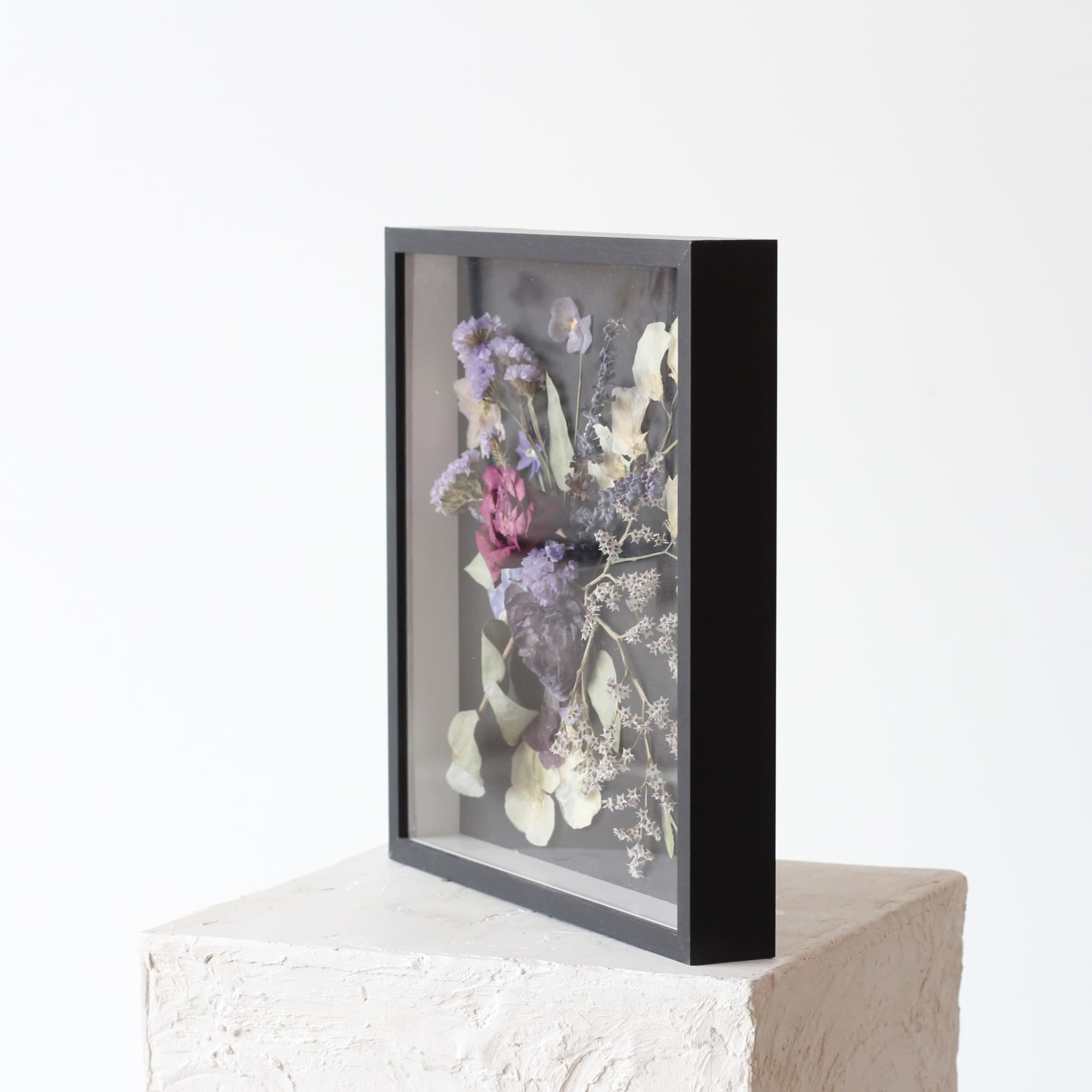 Framed pressed flowers in purple, white, and pink