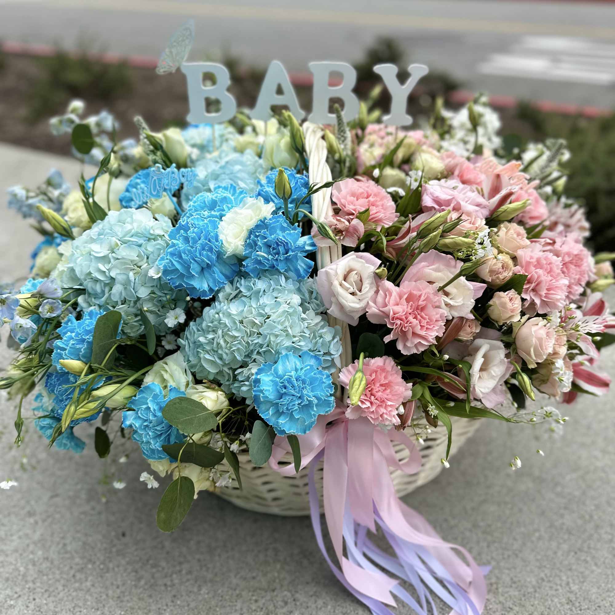 Basket arrangement of blue and pink flowers with a BABY sign, photo 2 of 4