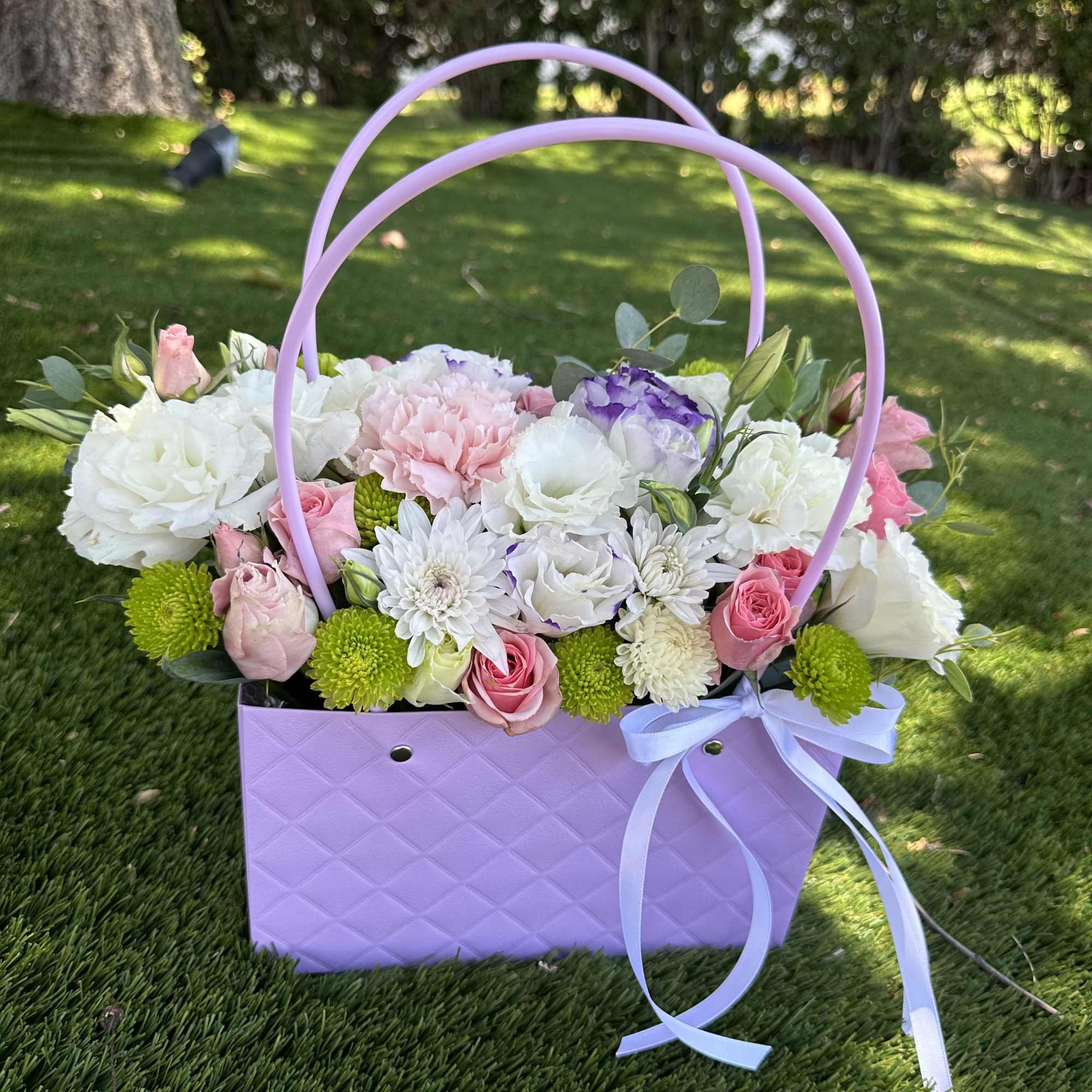 Lavender basket filled with pink, white, and purple flowers