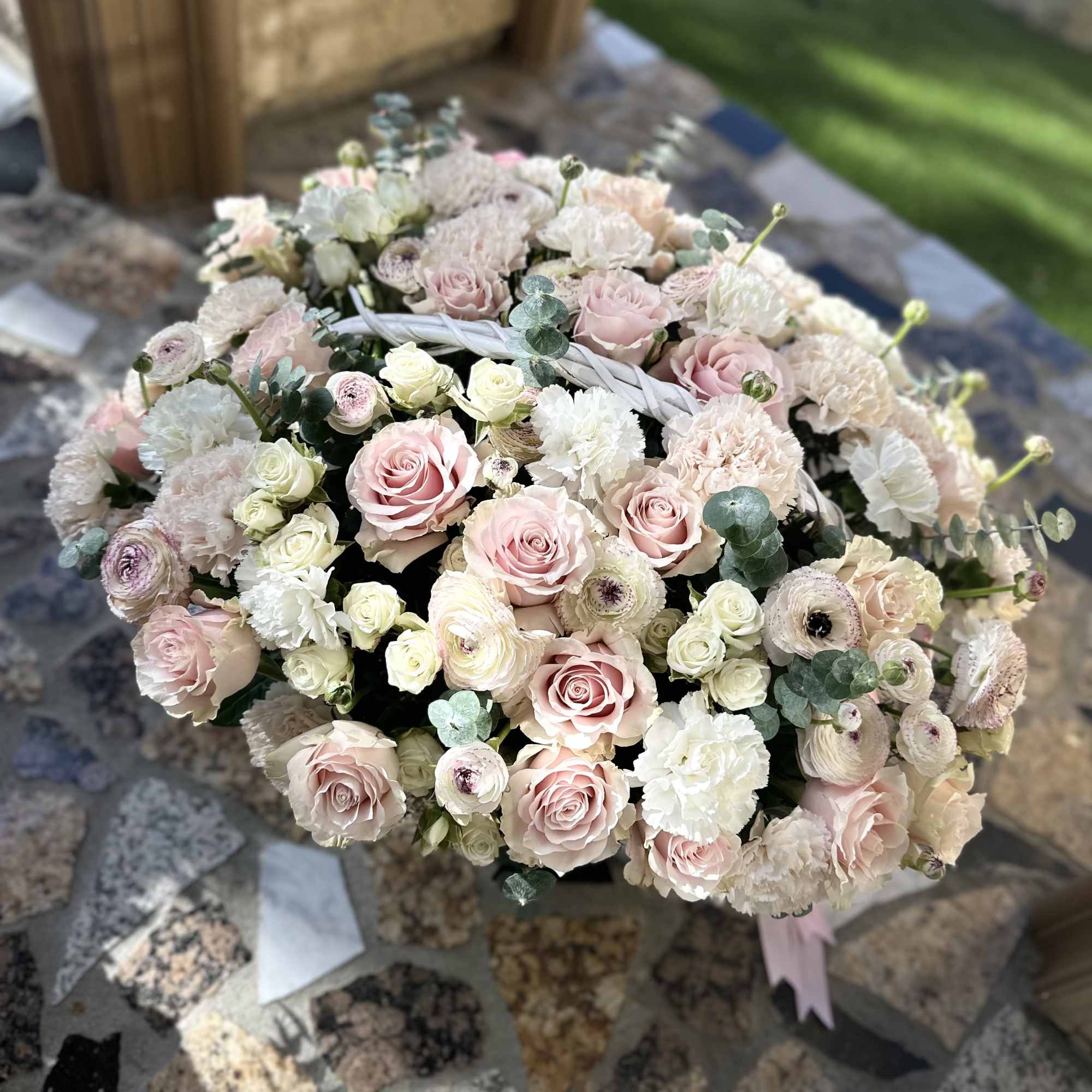 Large bouquet of pale pink and white flowers with eucalyptus accents