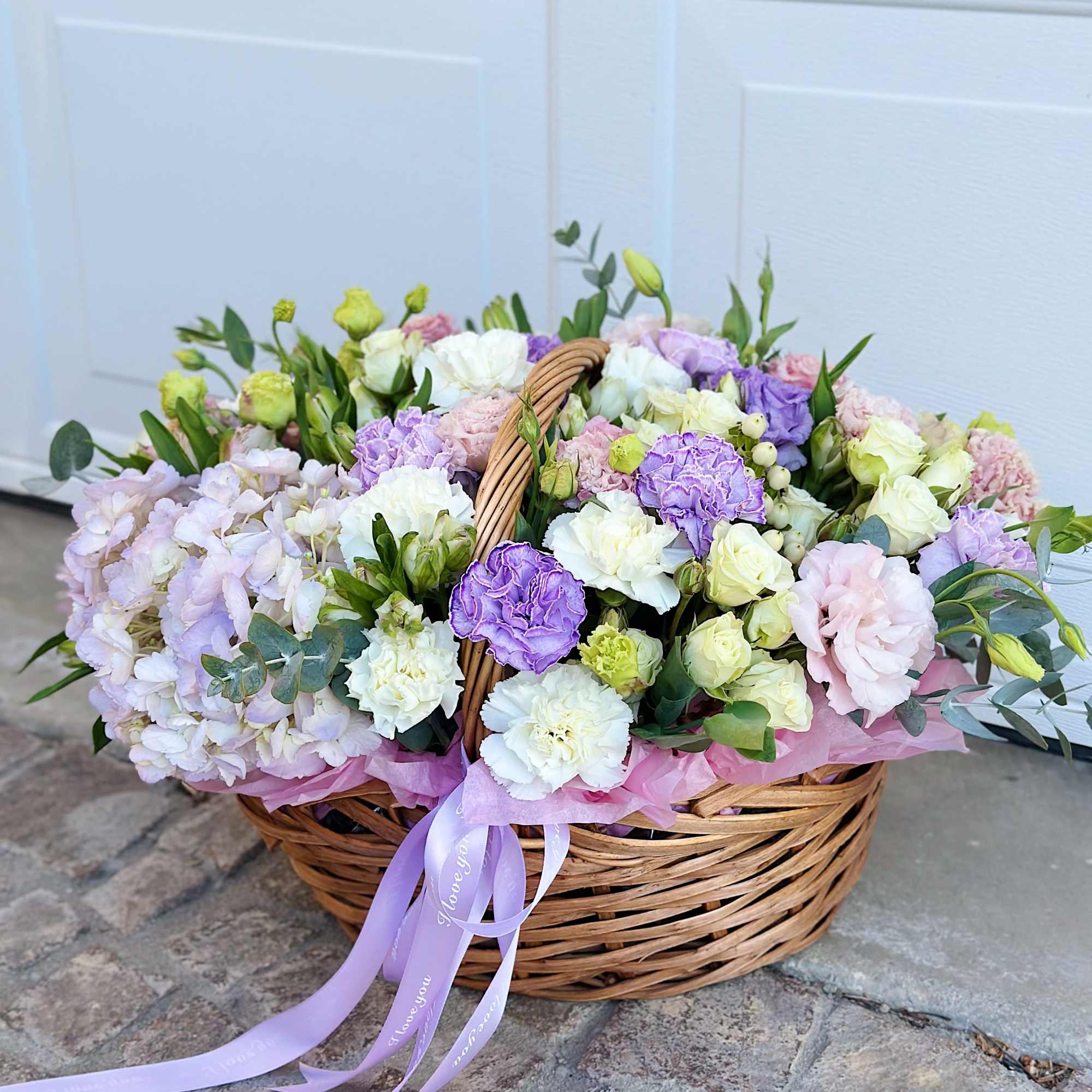 Pastel flower basket with roses, carnations, and hydrangeas
