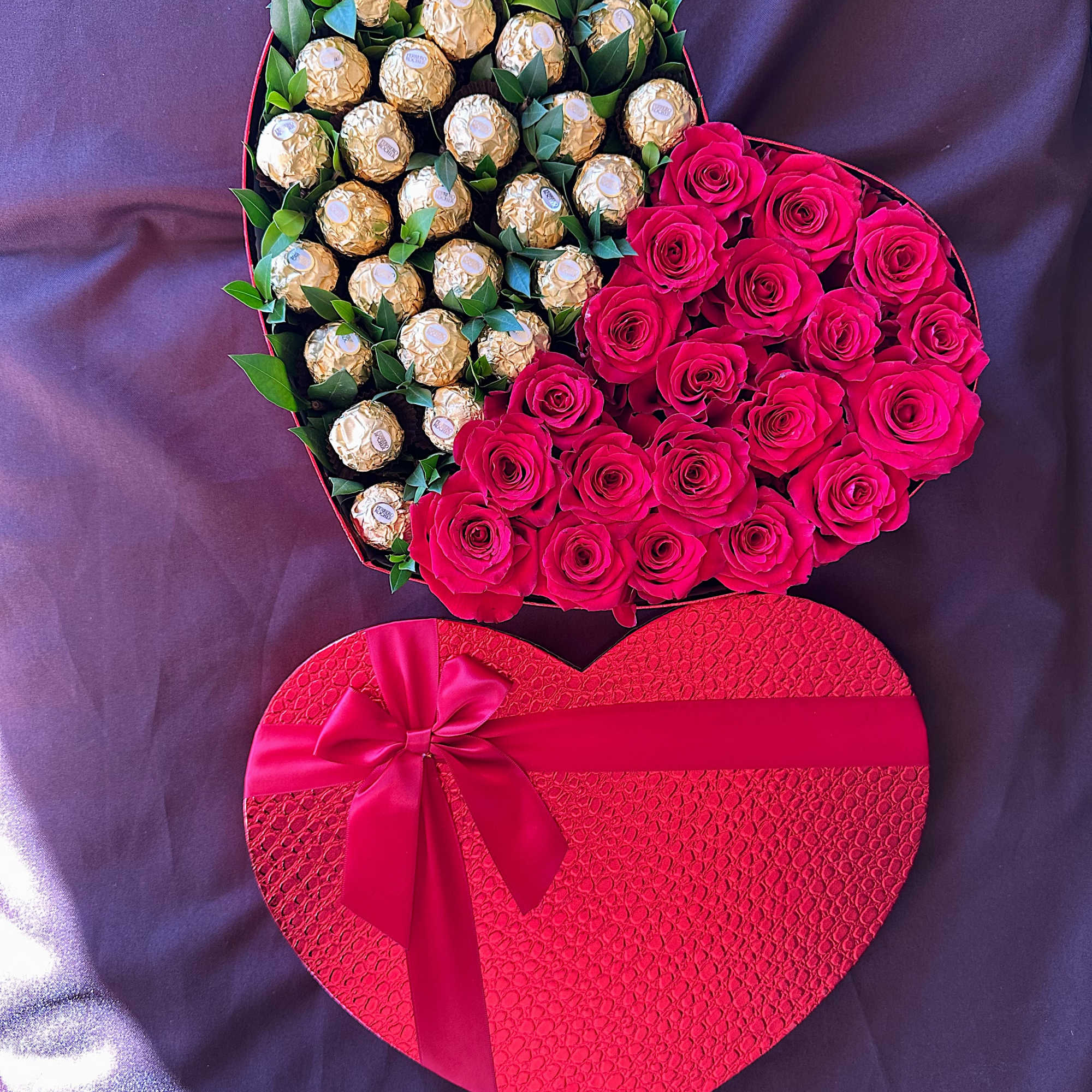 Heart-shaped box with pink roses and gold-wrapped chocolates